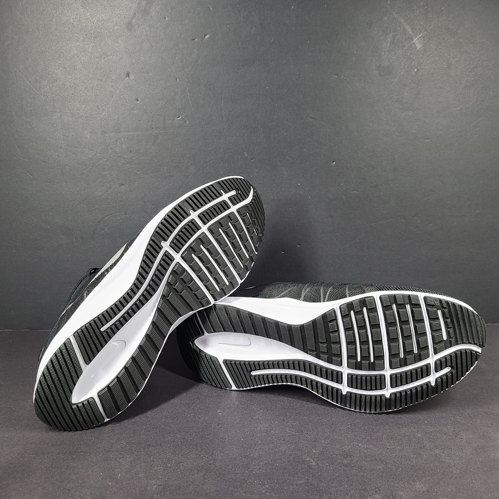 Sleek black Nike Quest 4 running shoes deliver lightweight cushioning and a streamlined fit for daily road runs.