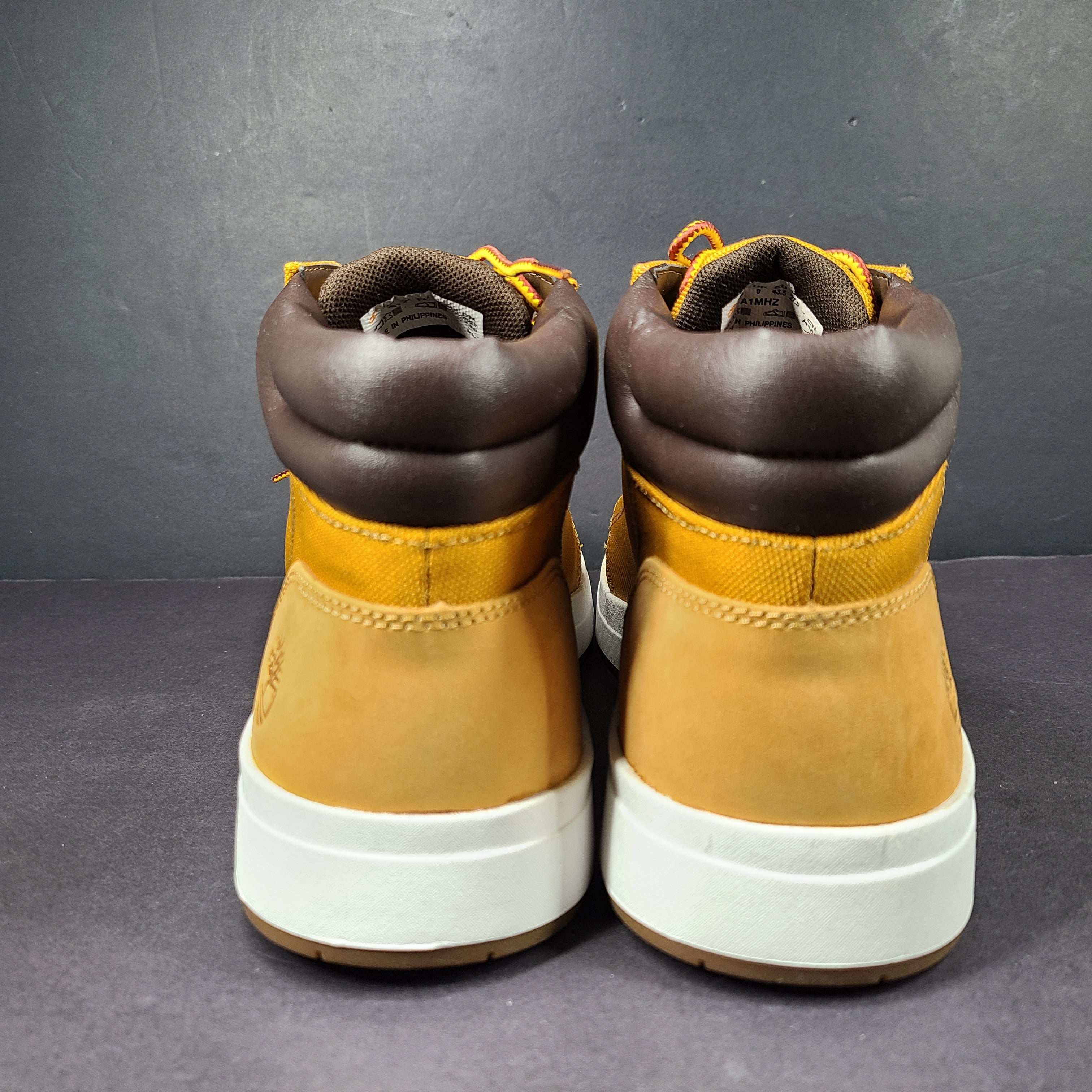 A pair of Timberland men’s sneakers in yellow and brown color.