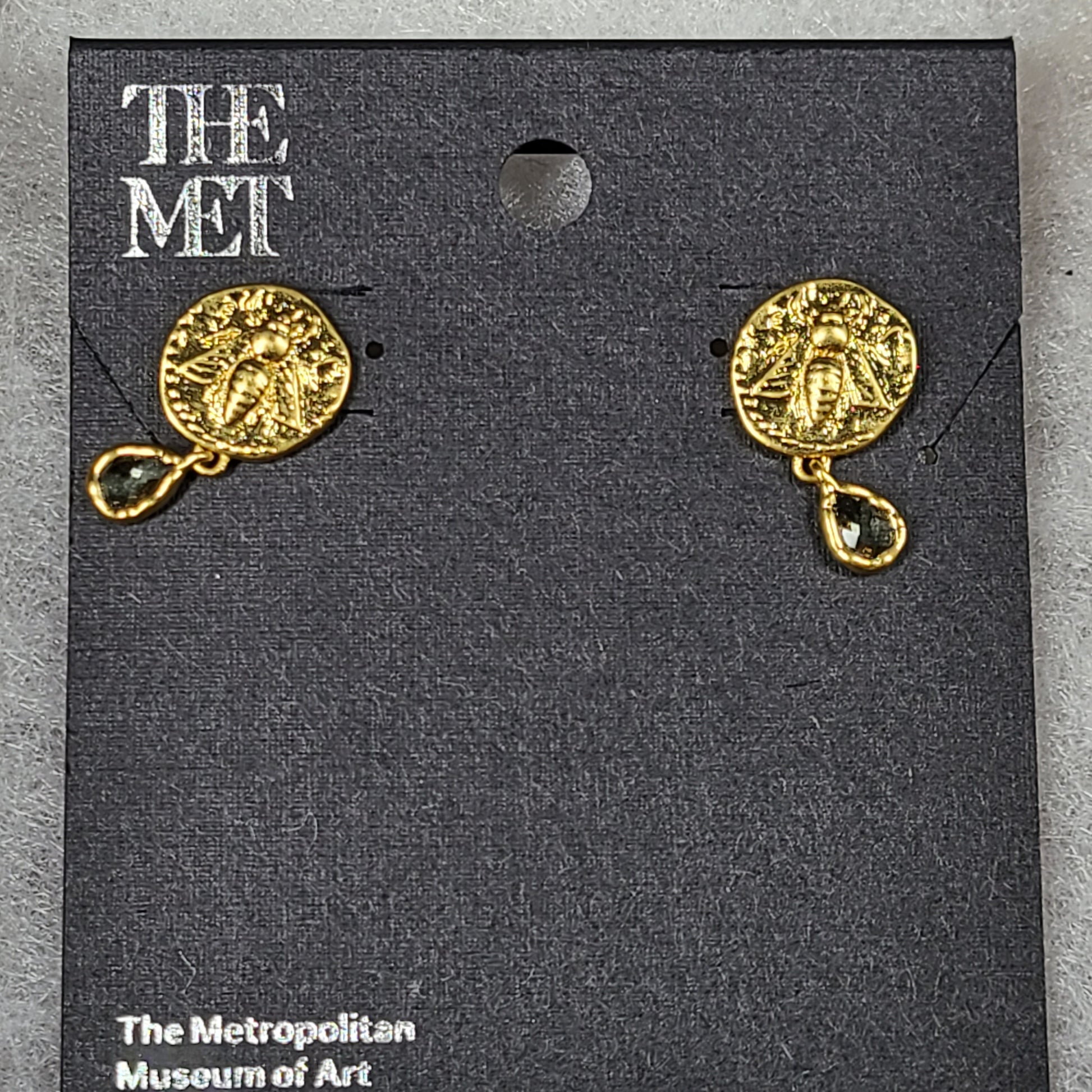 Gold Mediterranean coin stud earrings with secure posts and a timeless classical motif for everyday and evening wear.