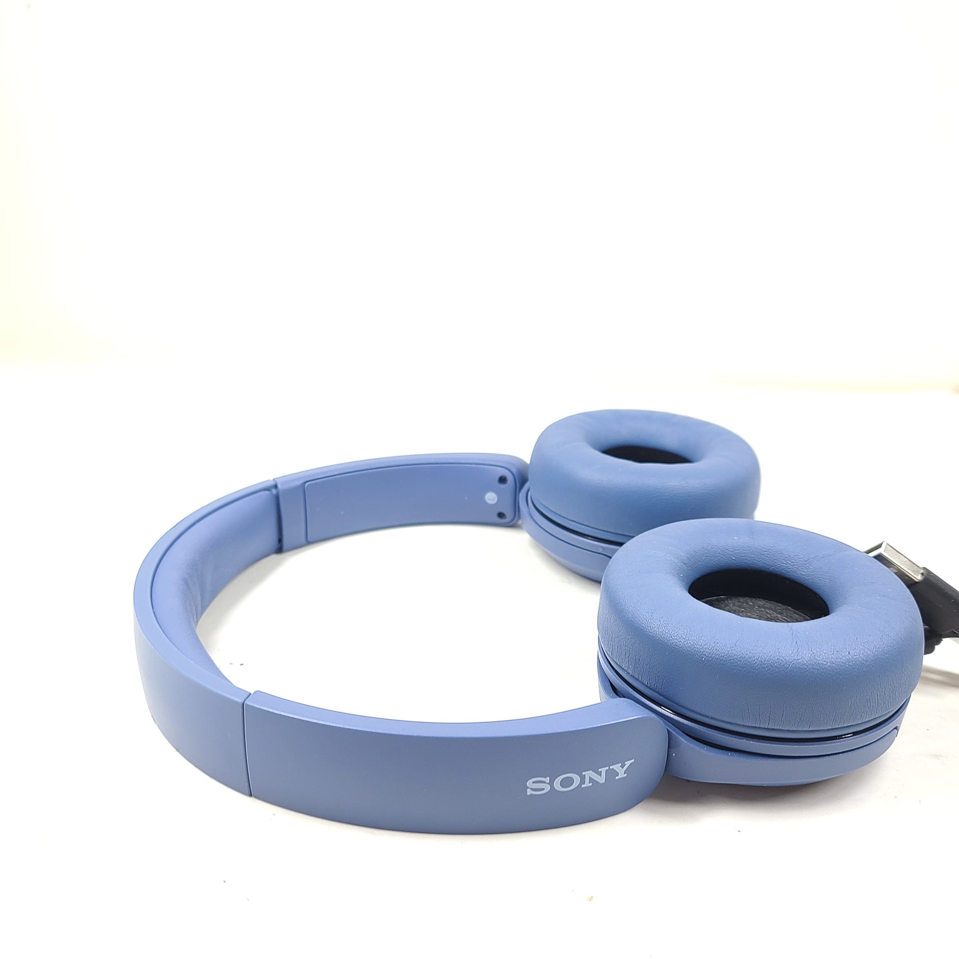 Blue Sony WH-CH520 on-ear headphones with a lightweight headband and Bluetooth connectivity for hands-free listening.