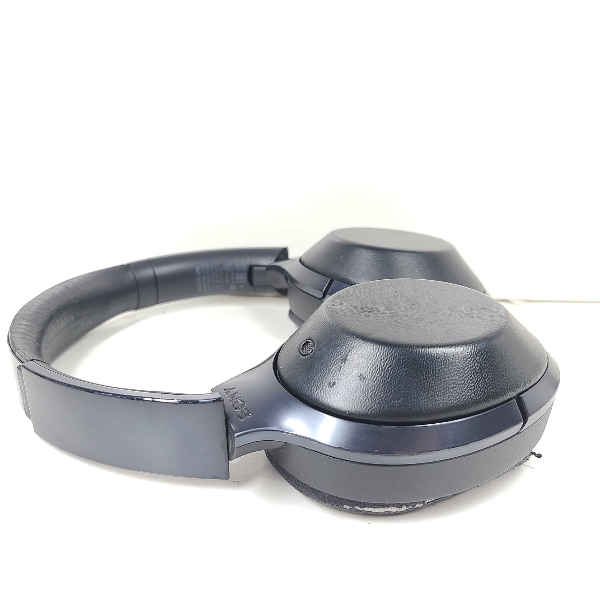 Over-ear Sony MDR-1000X headphones with active noise cancellation and a black finish.