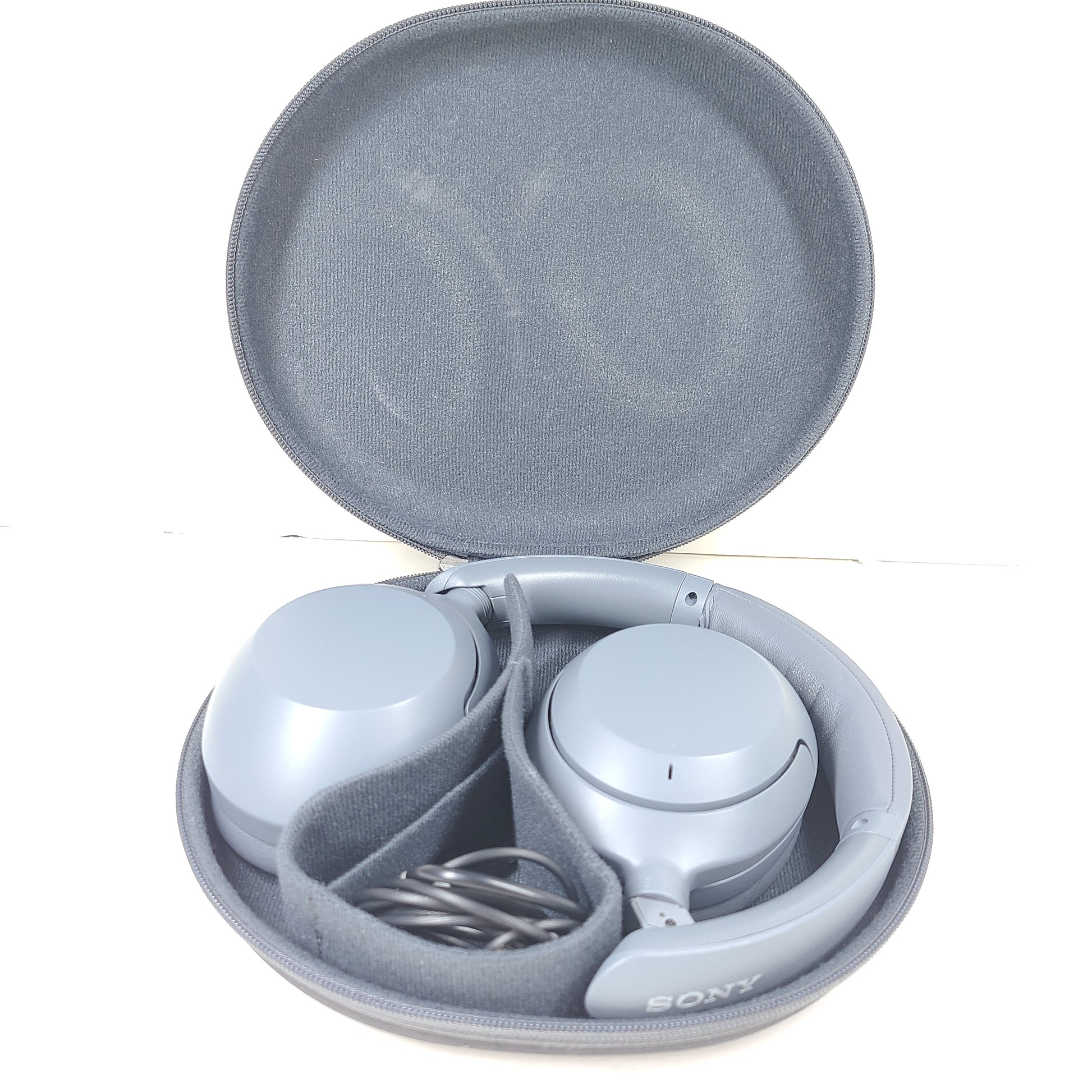 Premium wireless over-ear headphones with active noise cancellation and a cushioned headband in gray.