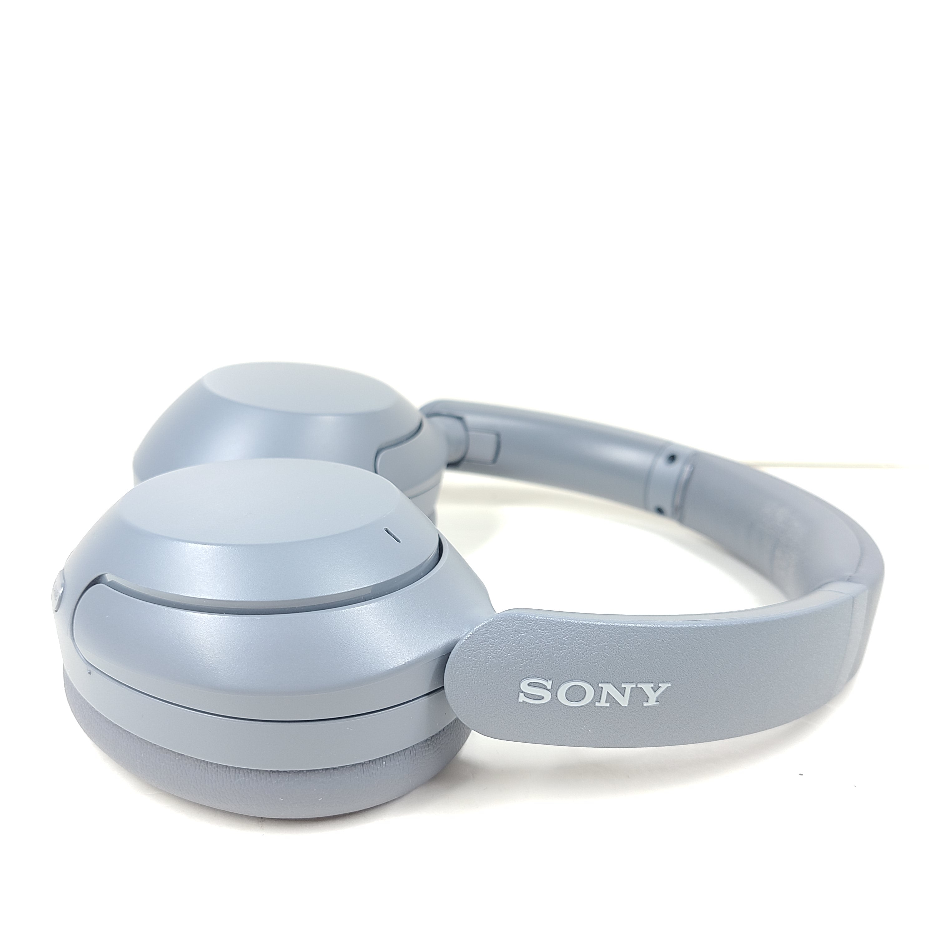 Premium wireless over-ear headphones with active noise cancellation and a cushioned headband in gray.
