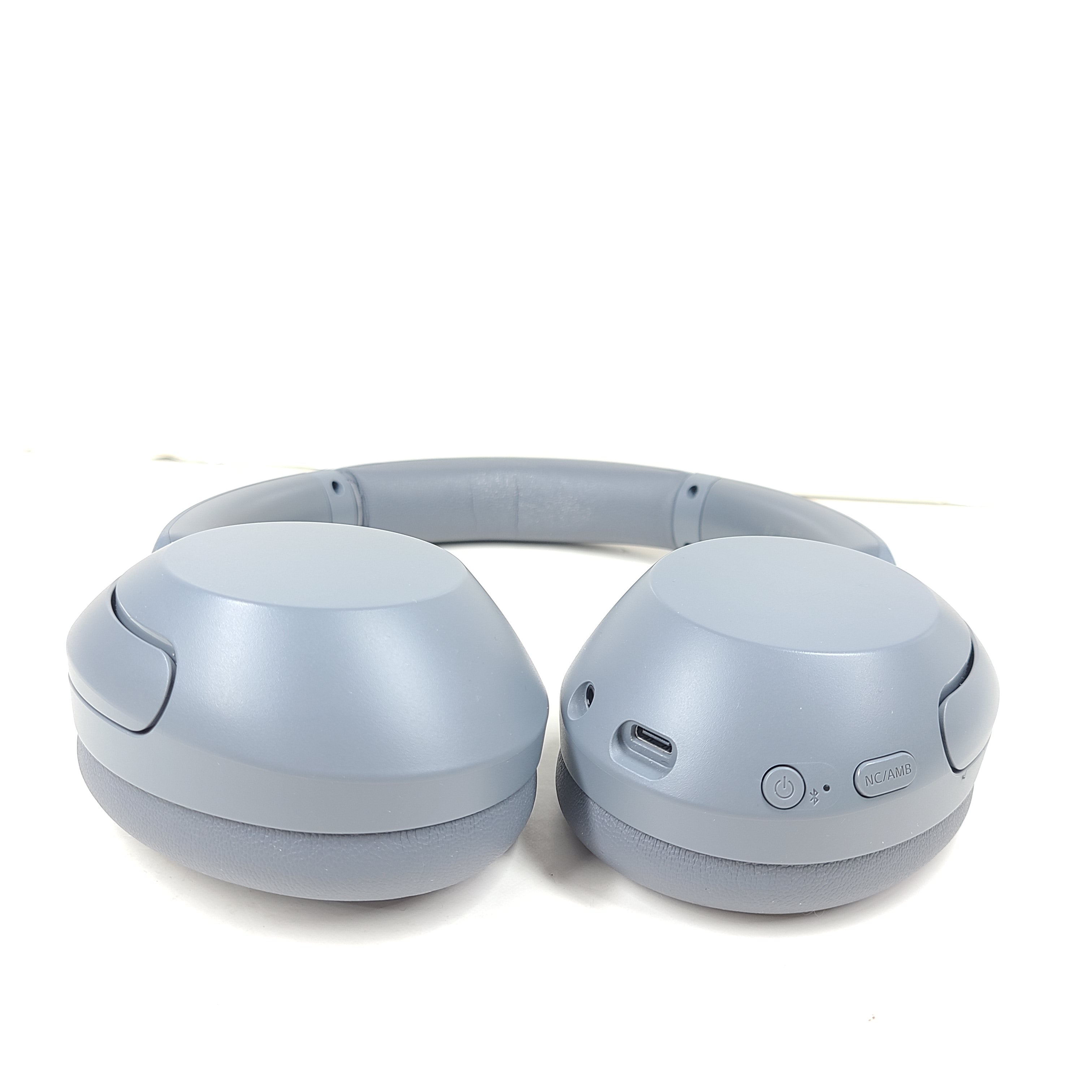 Premium wireless over-ear headphones with active noise cancellation and a cushioned headband in gray.