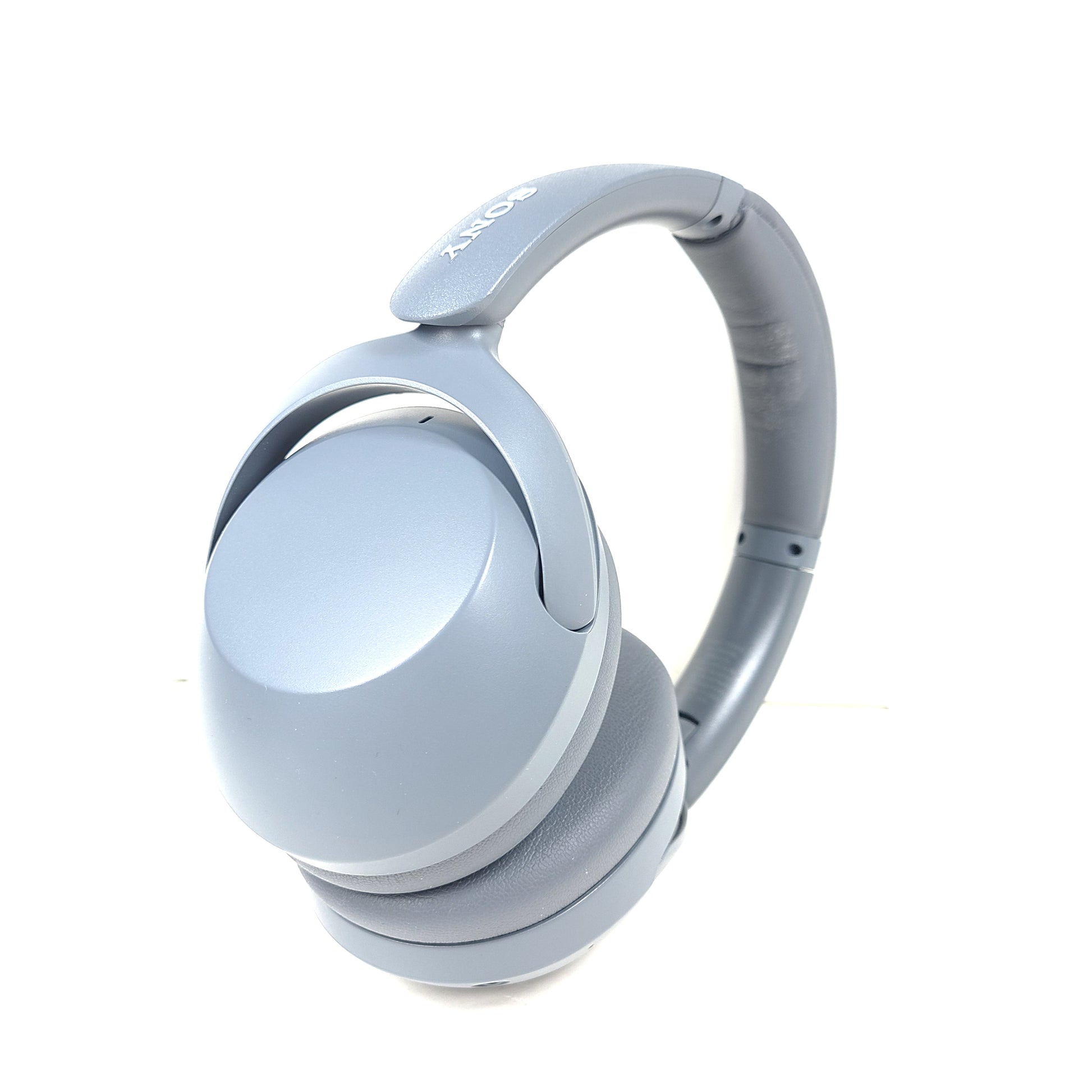 Premium wireless over-ear headphones with active noise cancellation and a cushioned headband in gray.