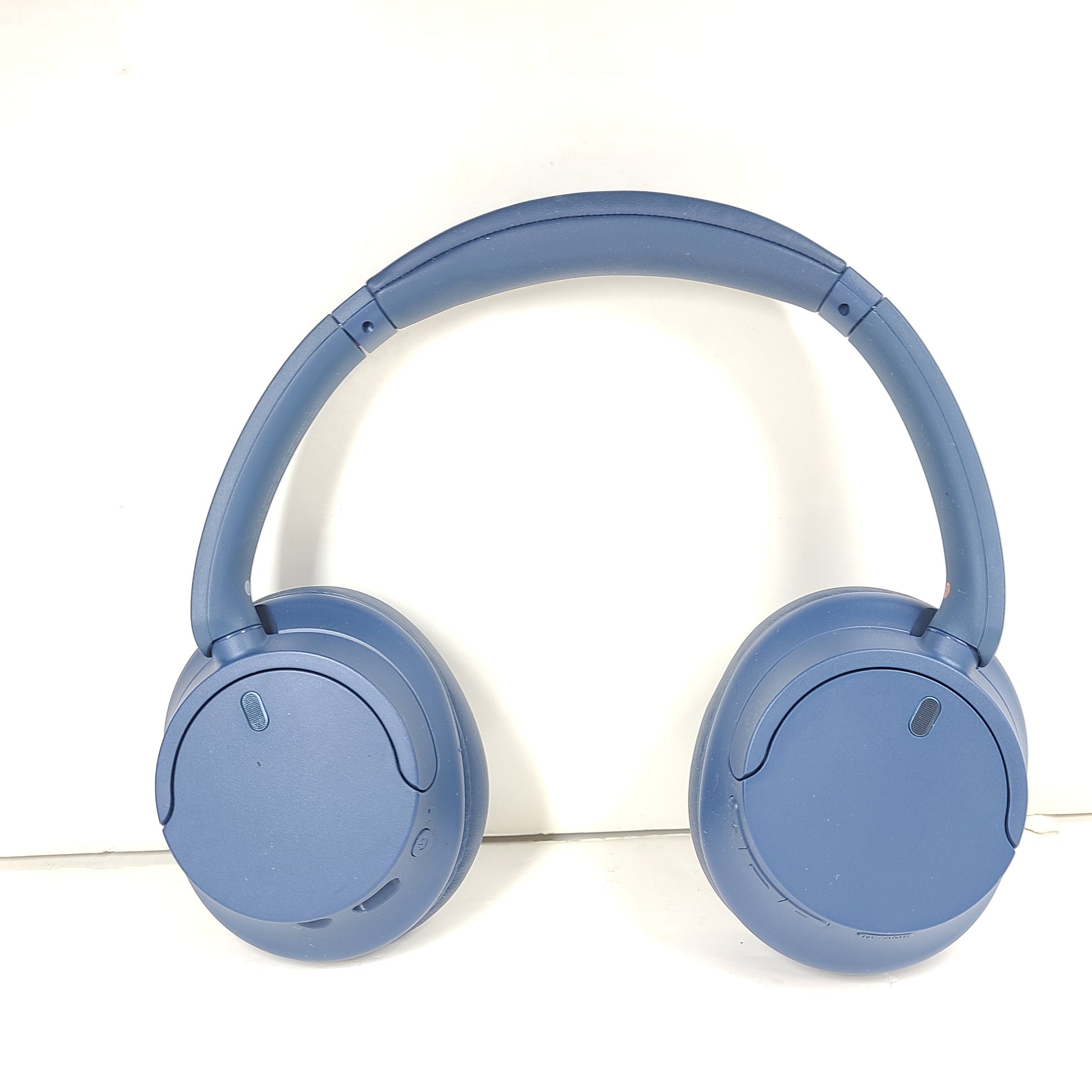 Blue Sony WH-CH720N wireless noise-cancelling over-ear headphones with padded ear cups and adjustable headband.