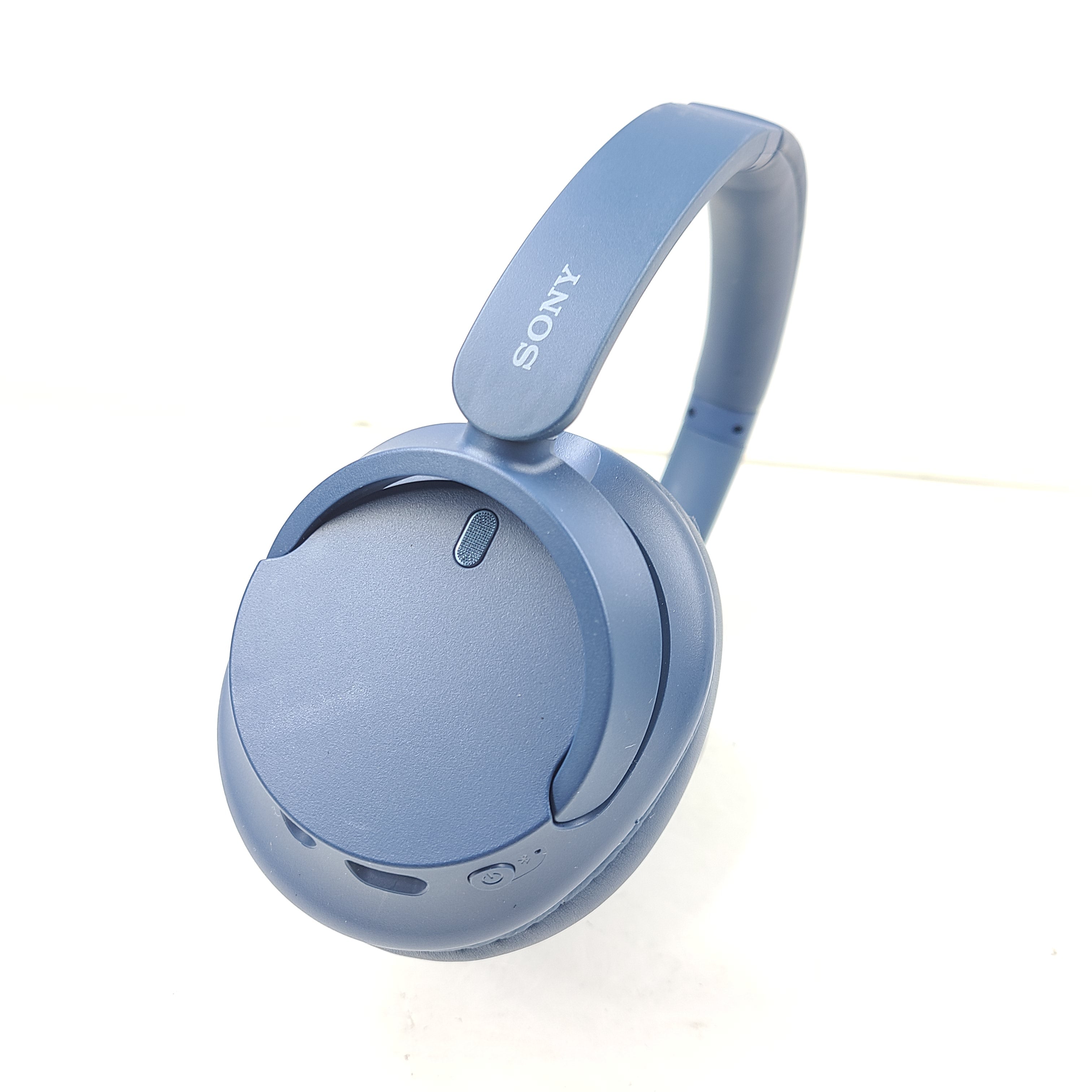 Blue Sony WH-CH720N wireless noise-cancelling over-ear headphones with padded ear cups and adjustable headband.