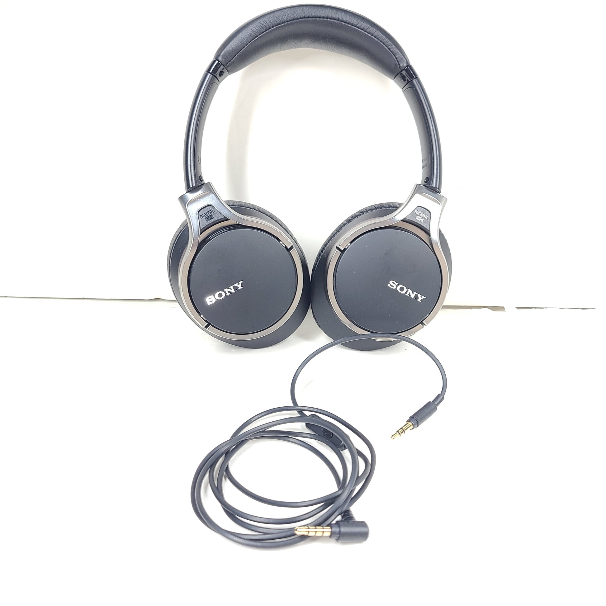 Black Sony MDR-10RNC on-ear noise-cancelling headphones with DIGITAL NC labeling and attached cable.
