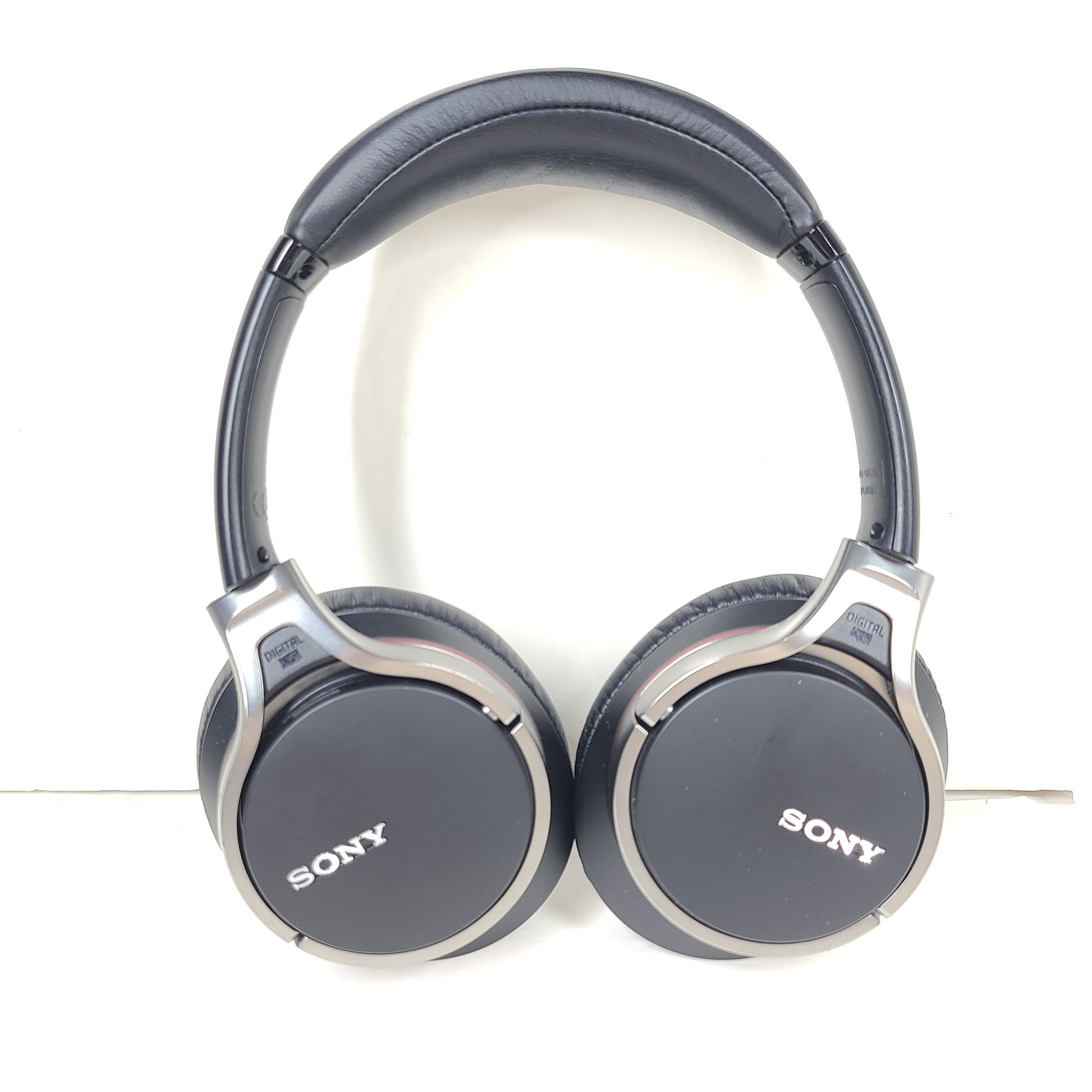 Black Sony MDR-10RNC on-ear noise-cancelling headphones with DIGITAL NC labeling and attached cable.