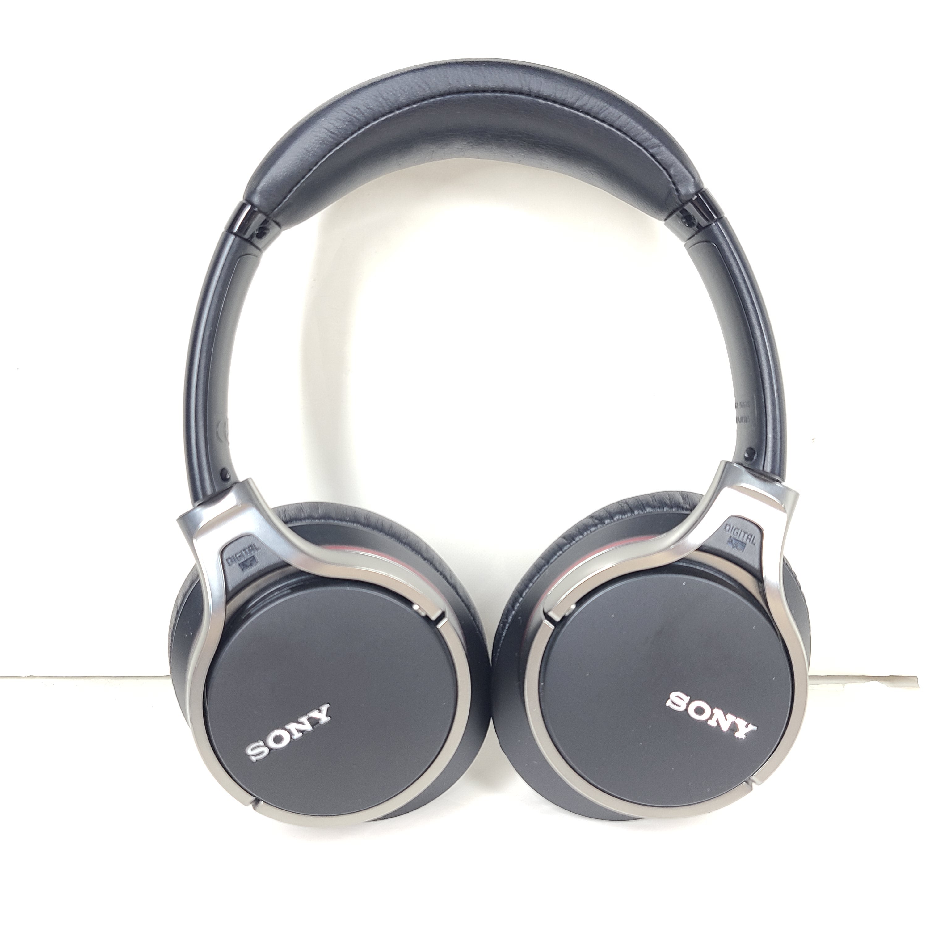 Black Sony MDR-10RNC on-ear noise-cancelling headphones with DIGITAL NC labeling and attached cable.