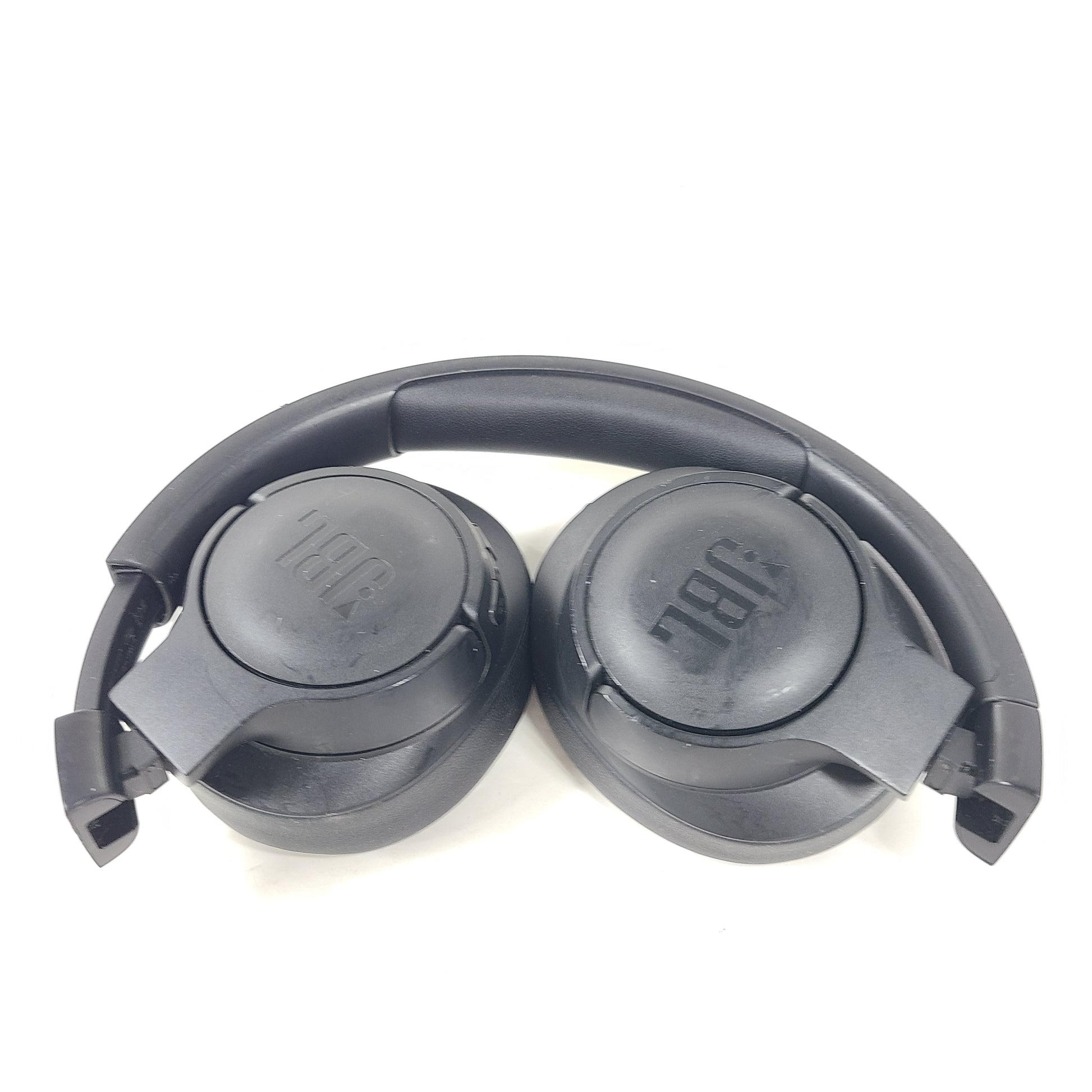 Over-ear JBL Tune 710BT wireless headphones in black with cushioned ear pads and adjustable headband for comfortable listening.
