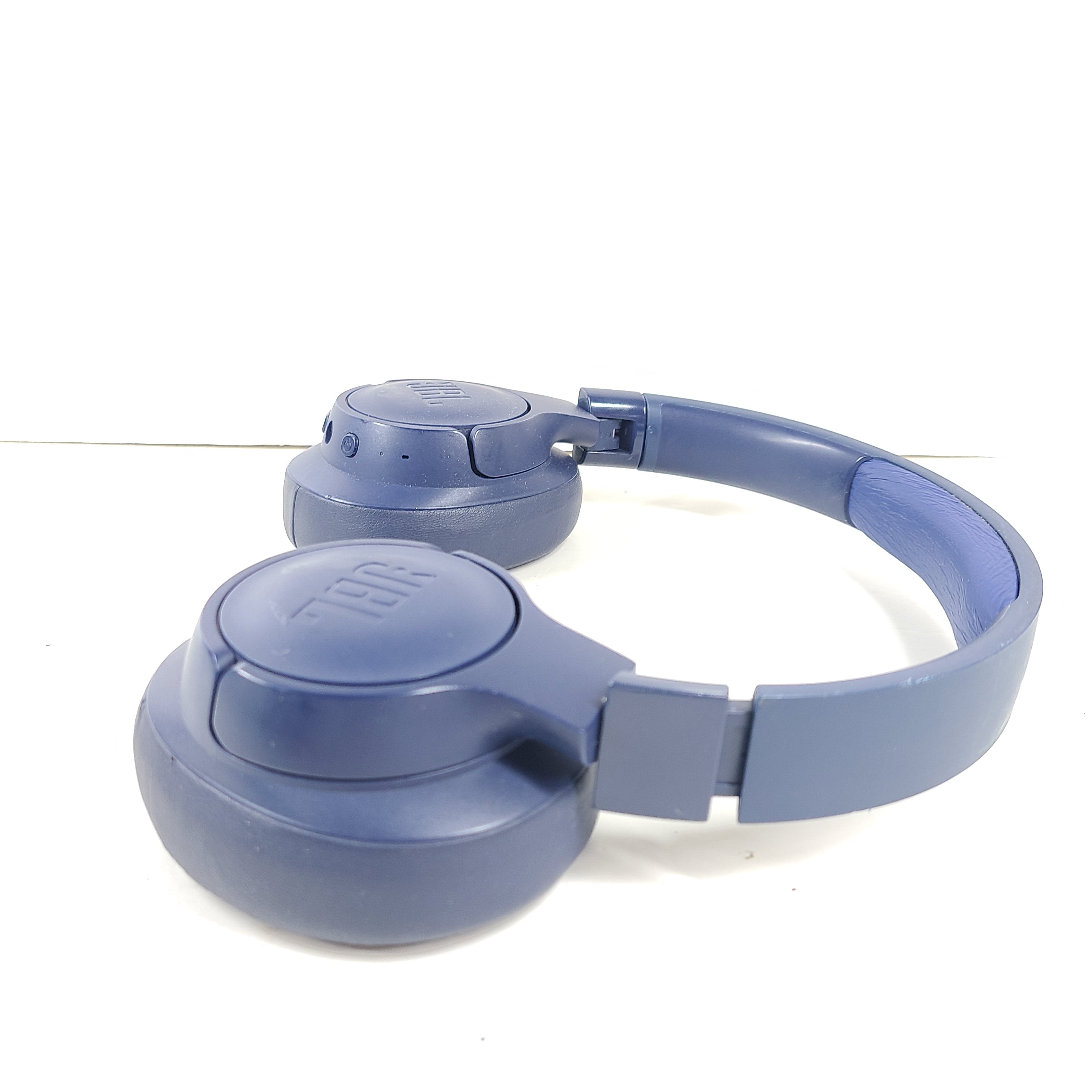 Blue JBL TUNE700BT wireless over-ear headphones with cushioned earcups and adjustable headband.