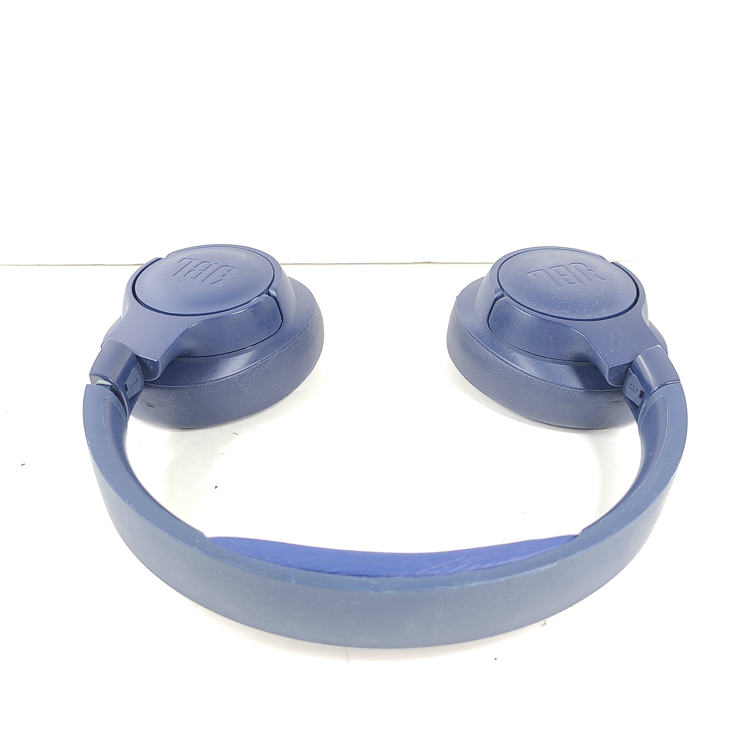 Blue JBL TUNE700BT wireless over-ear headphones with cushioned earcups and adjustable headband.
