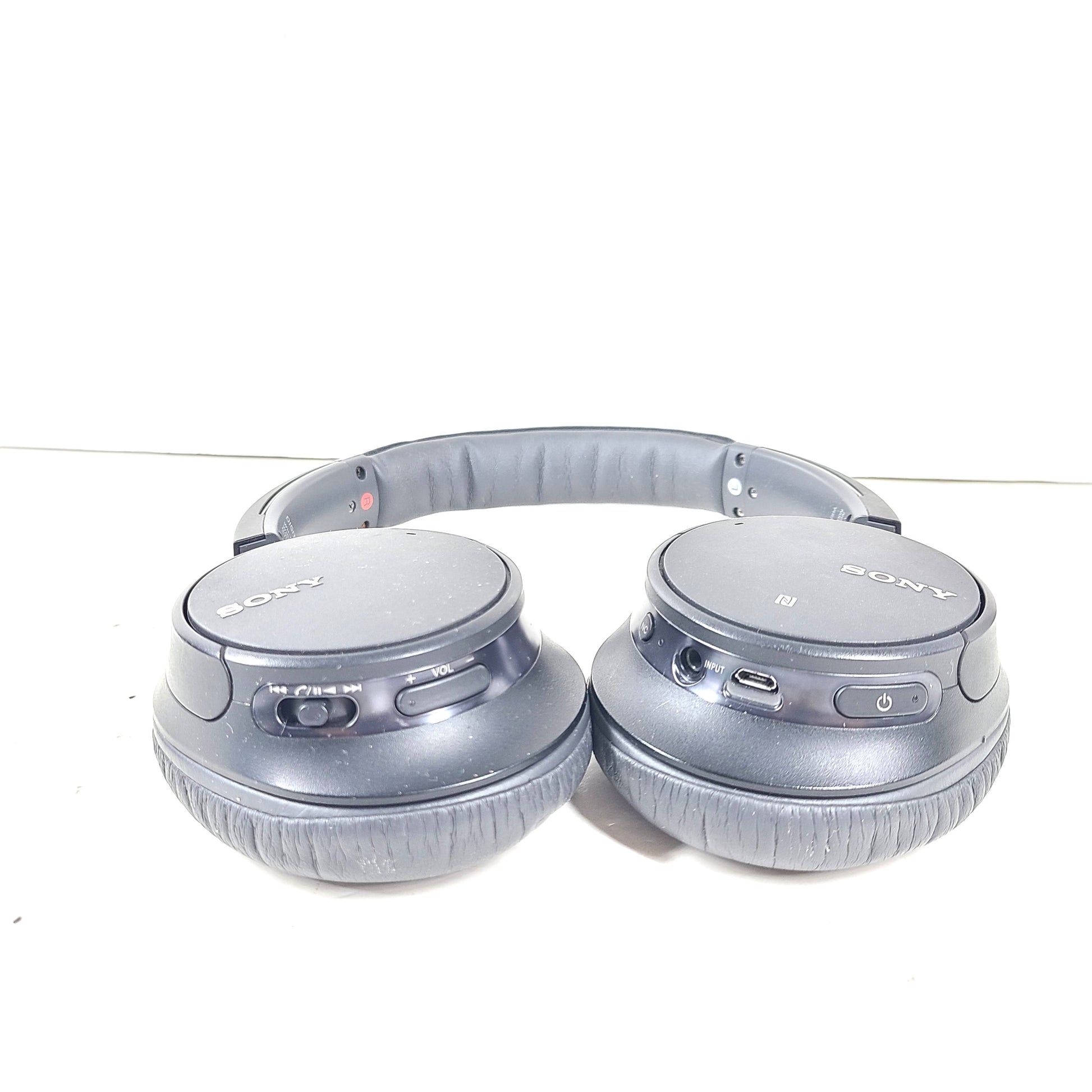 Sony WH-CH700N wireless noise-canceling over-ear headphones in dark grey with an attached 3.5mm audio cable.