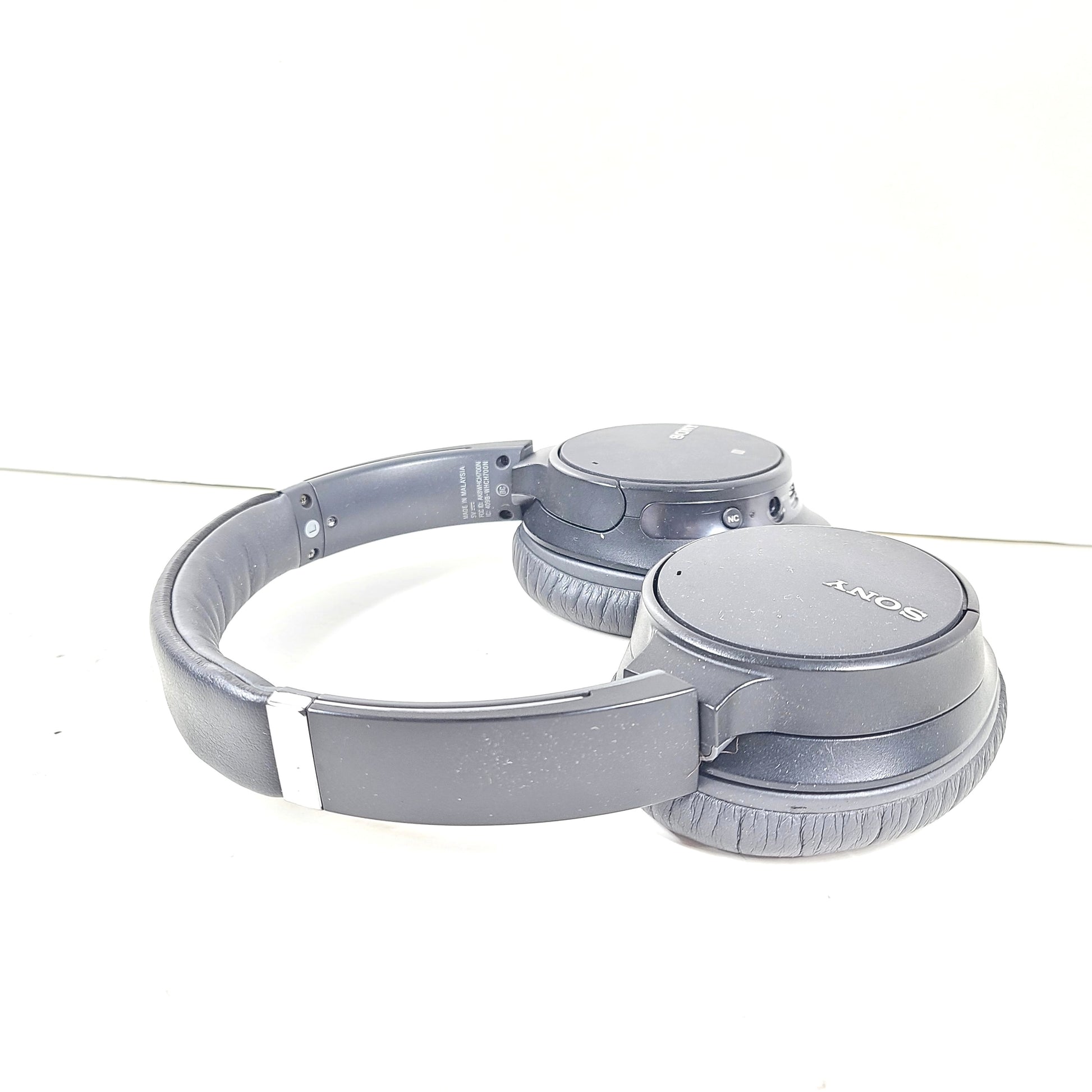 Sony WH-CH700N wireless noise-canceling over-ear headphones in dark grey with an attached 3.5mm audio cable.