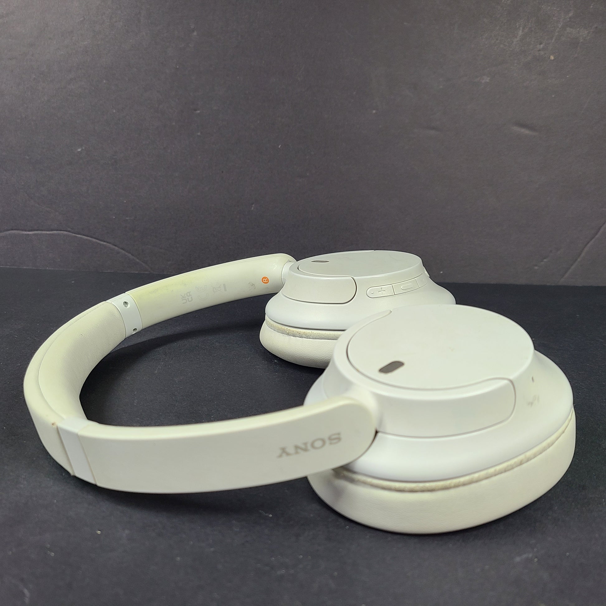 White Sony WH-CH720N over-ear noise-cancelling headphones with adjustable headband and control buttons.