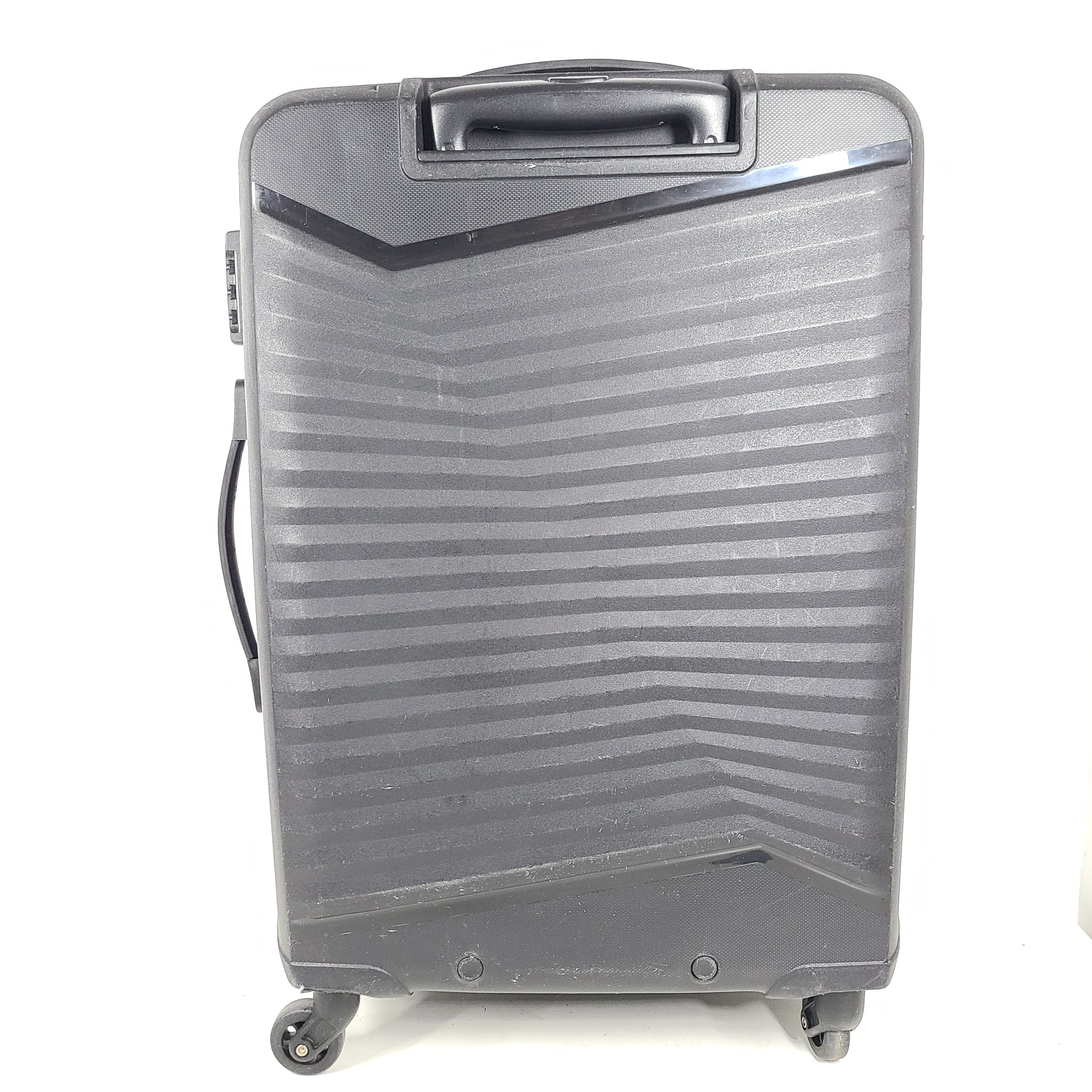 Black Kamiliant hard-shell spinner suitcase with four smooth-rolling wheels and a telescoping handle.