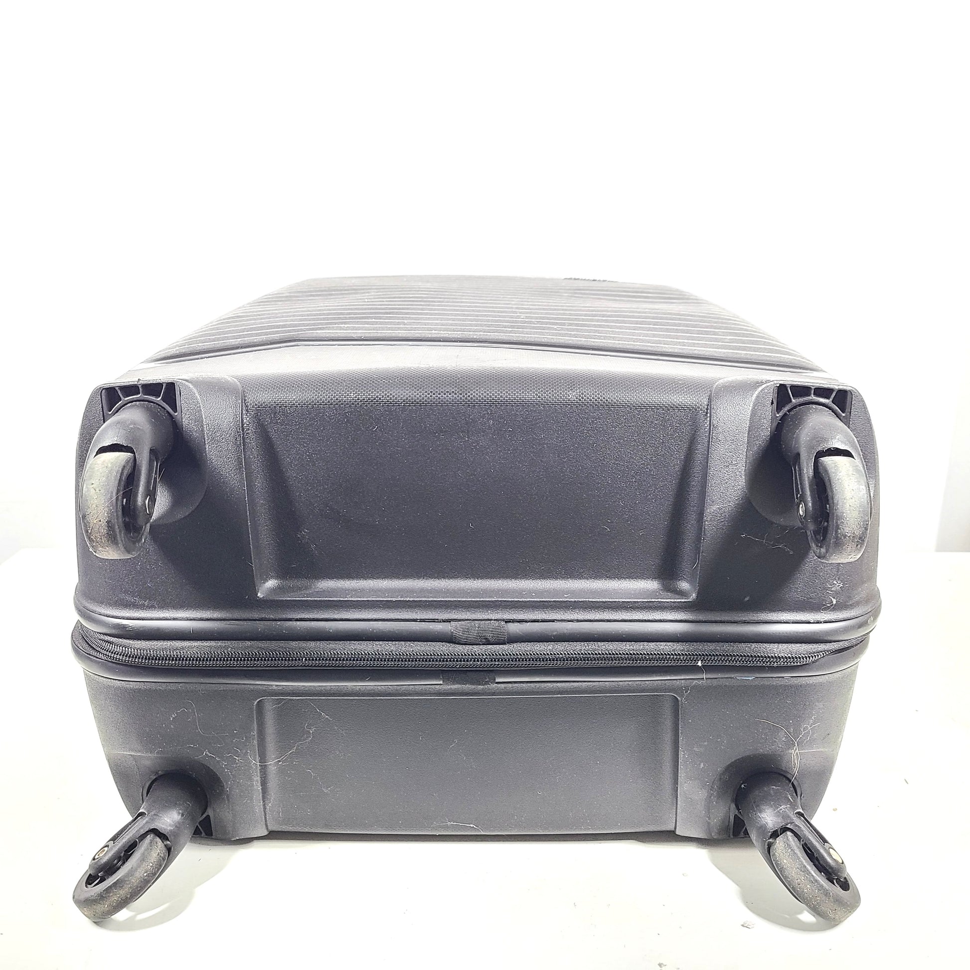 Black Kamiliant hard-shell spinner suitcase with four smooth-rolling wheels and a telescoping handle.