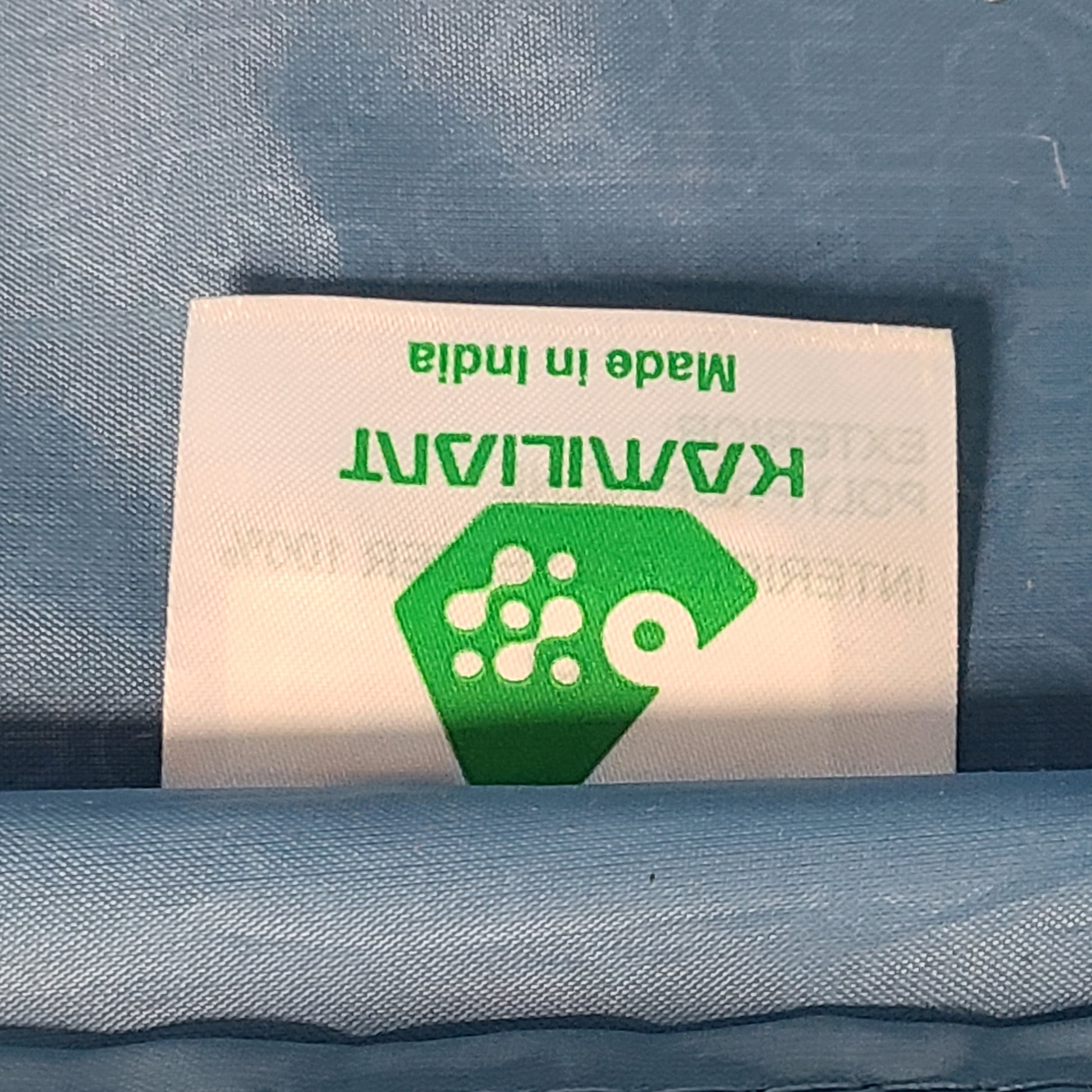 Black Kamiliant hard-shell spinner suitcase with four smooth-rolling wheels and a telescoping handle.