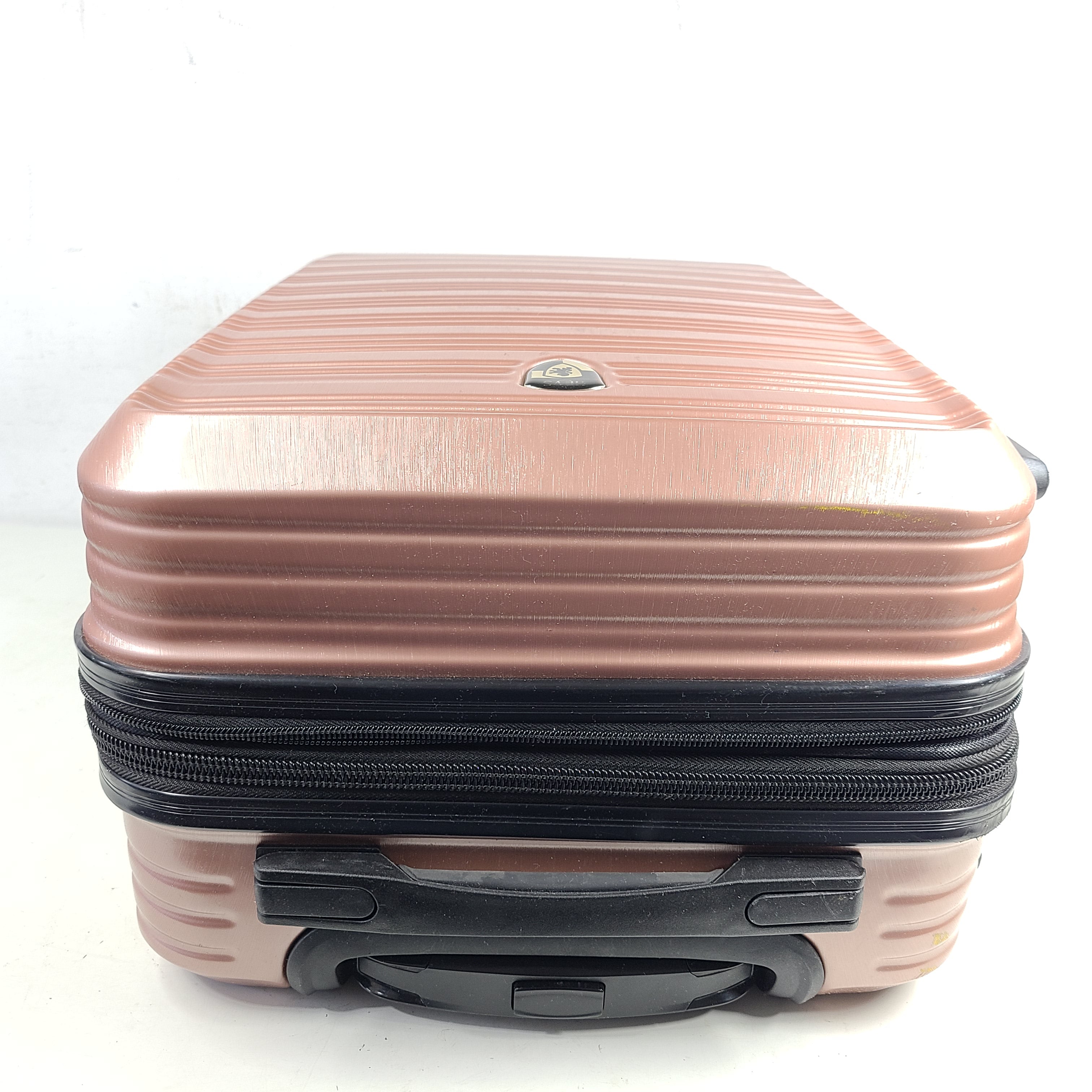 Rose gold Heys Aerolite hardshell carry-on with spinner wheels and telescoping handle for smooth travel.