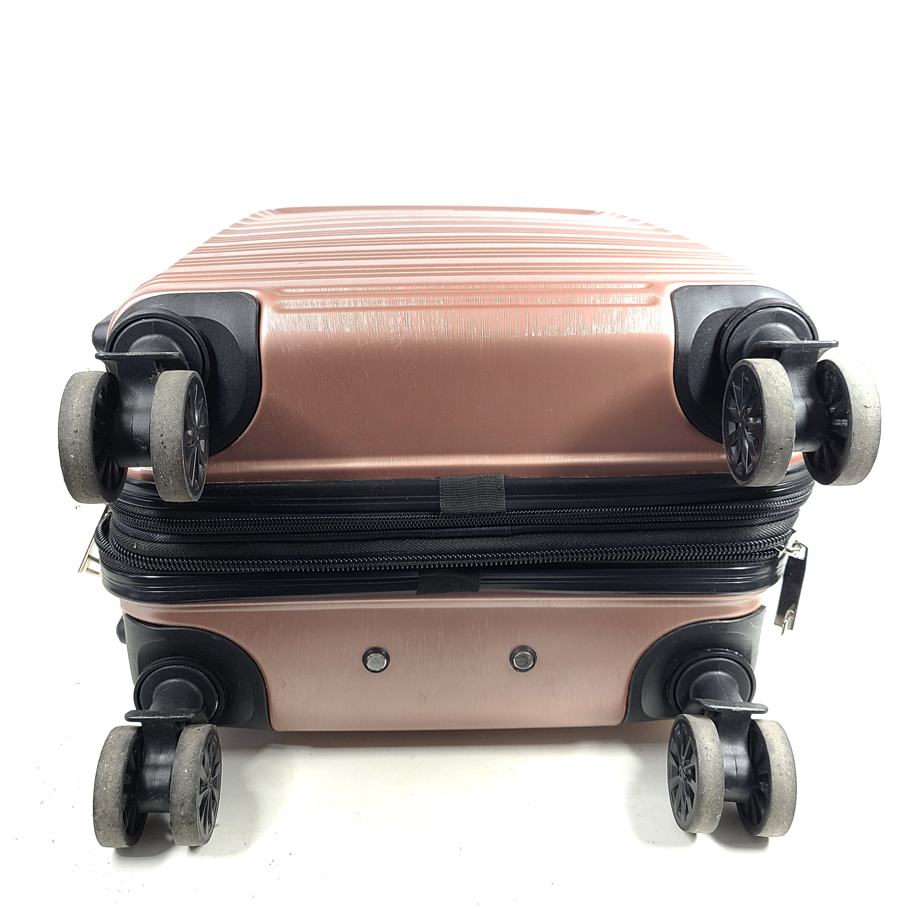 Rose gold Heys Aerolite hardshell carry-on with spinner wheels and telescoping handle for smooth travel.