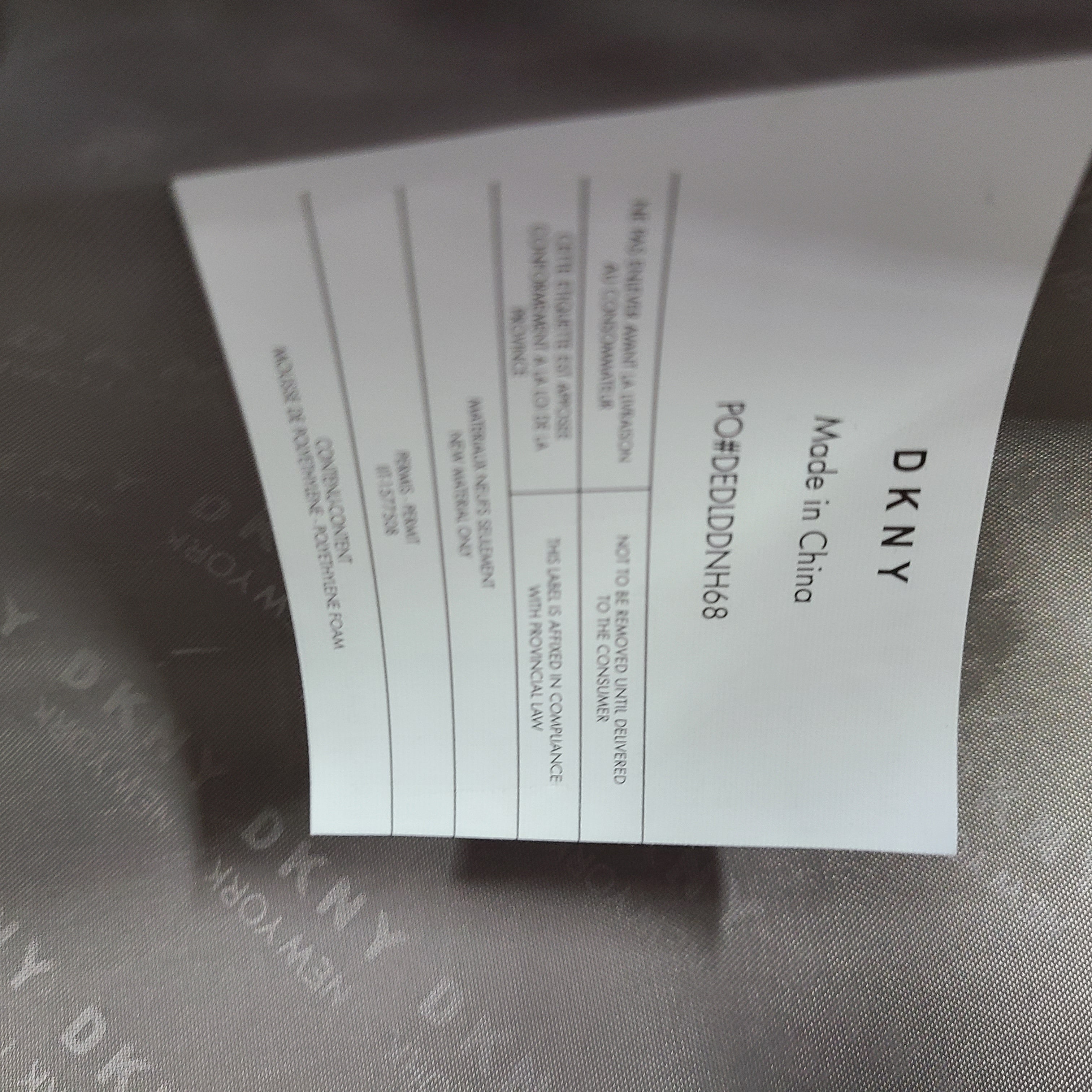 Gold DKNY suitcase with minor surface scratches and a clean interior, branded DKNY NEW YORK EST.1989.