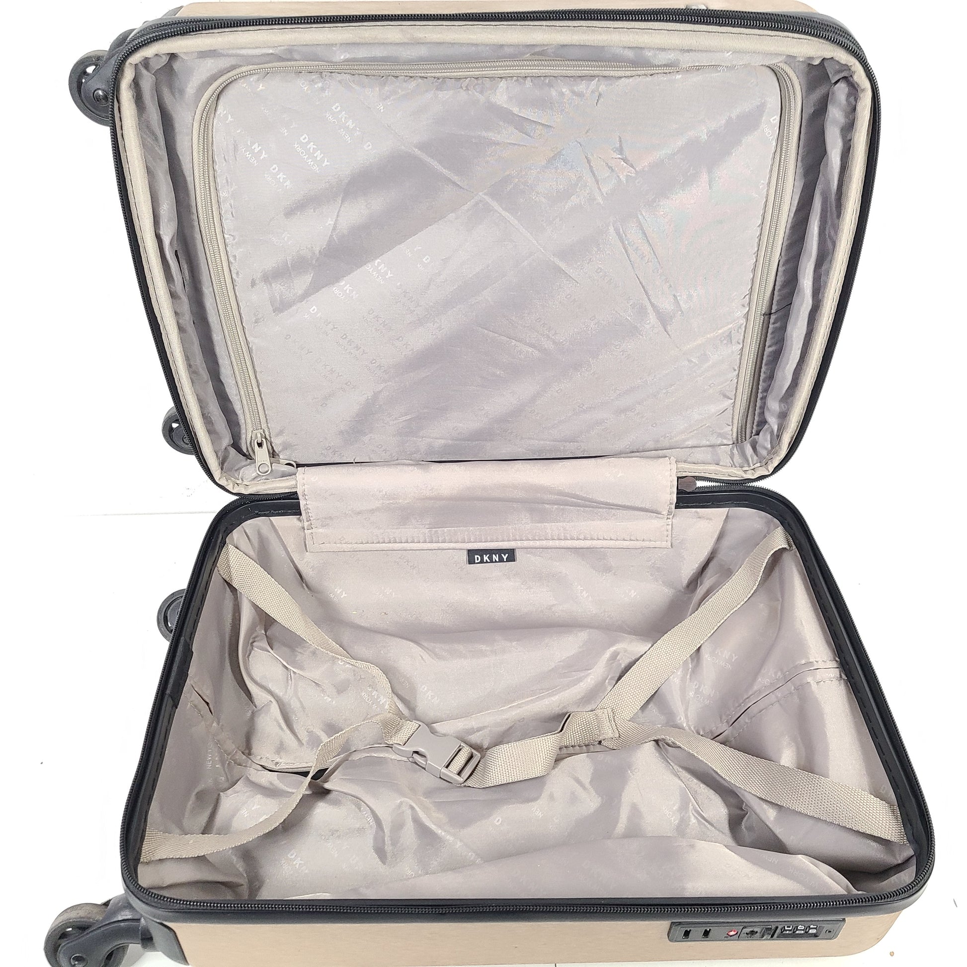 Gold DKNY suitcase with minor surface scratches and a clean interior, branded DKNY NEW YORK EST.1989.