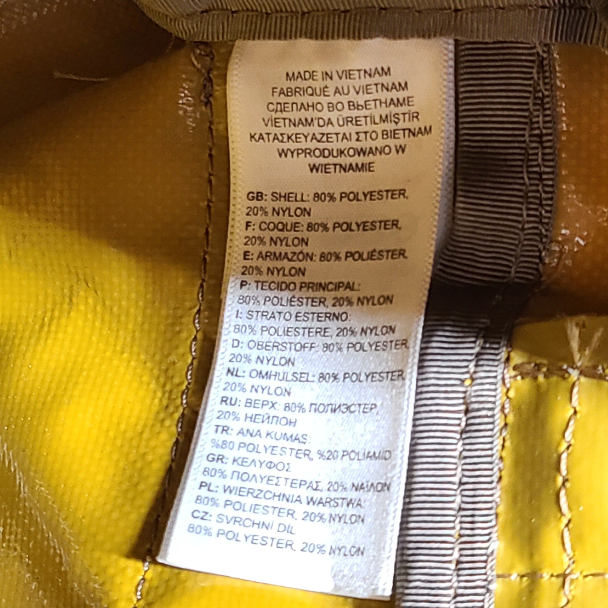 The North Face medium Base Camp duffel in yellow and grey with reinforced handles and adjustable shoulder straps.