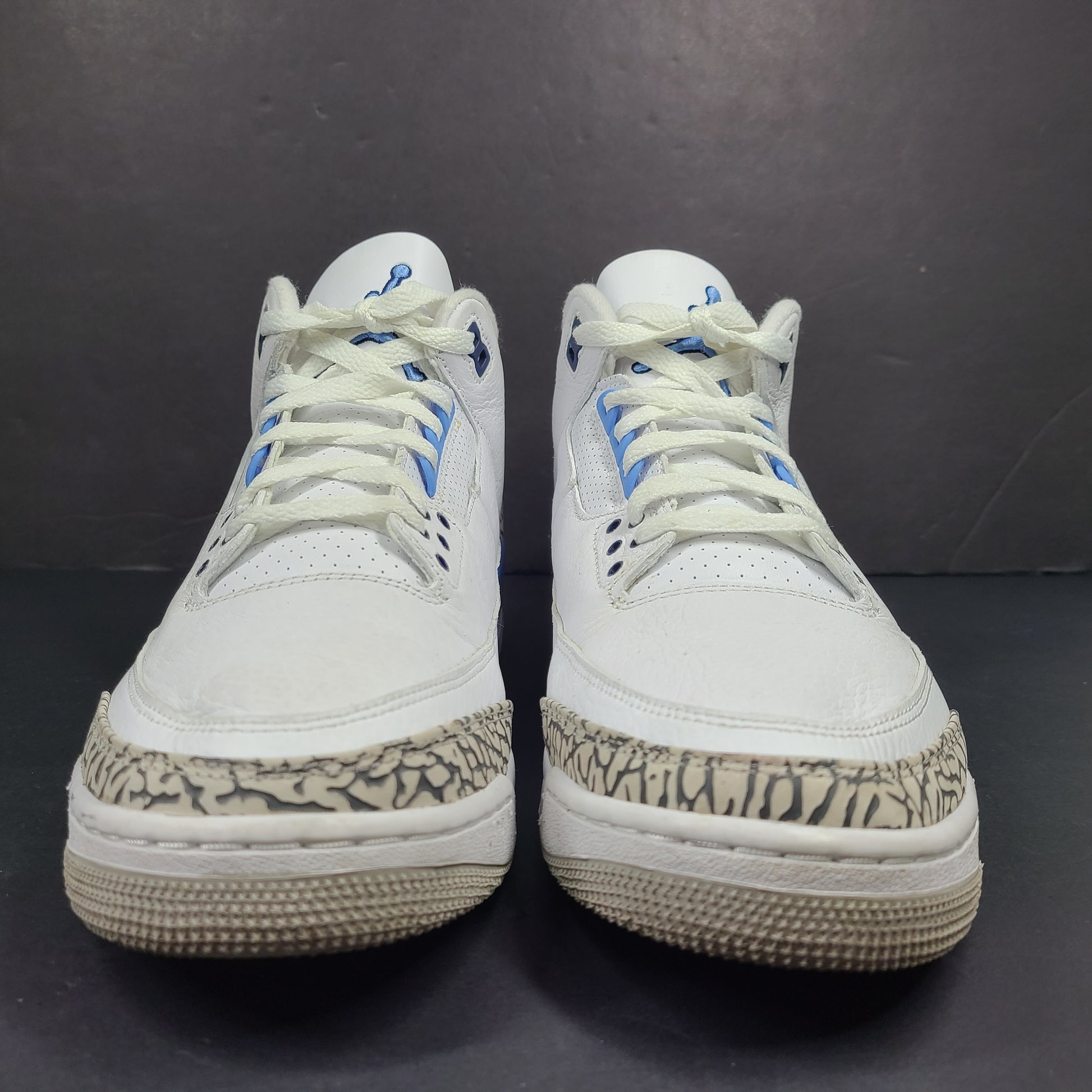 Air Jordan 3 Retro UNC in white and valor blue with elephant-print accents and blue detailing.