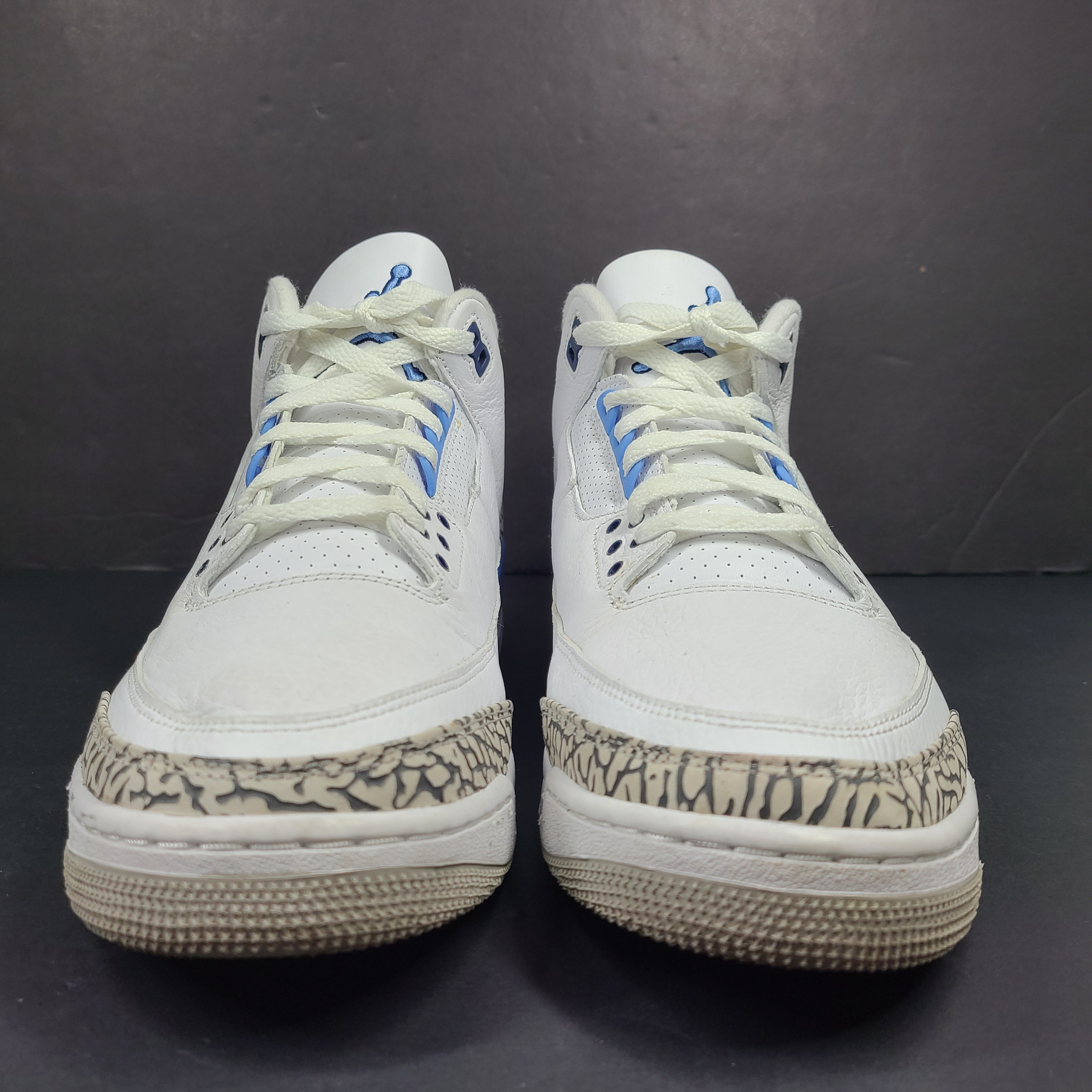 Air Jordan 3 Retro UNC in white and valor blue with elephant-print accents and blue detailing.