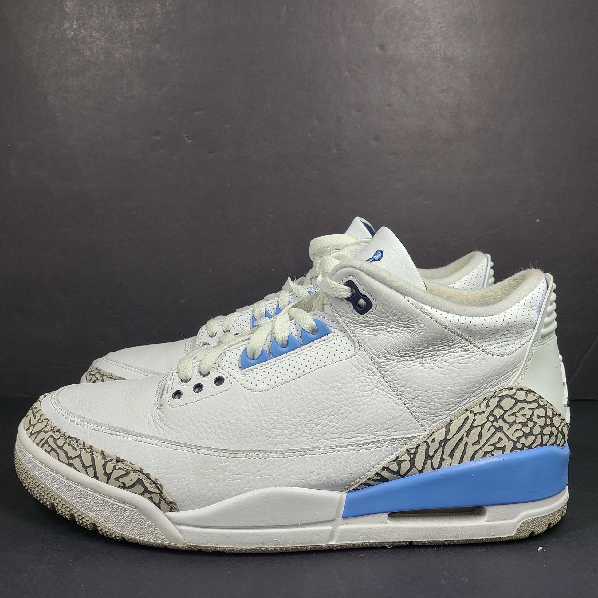 Air Jordan 3 Retro UNC in white and valor blue with elephant-print accents and blue detailing.