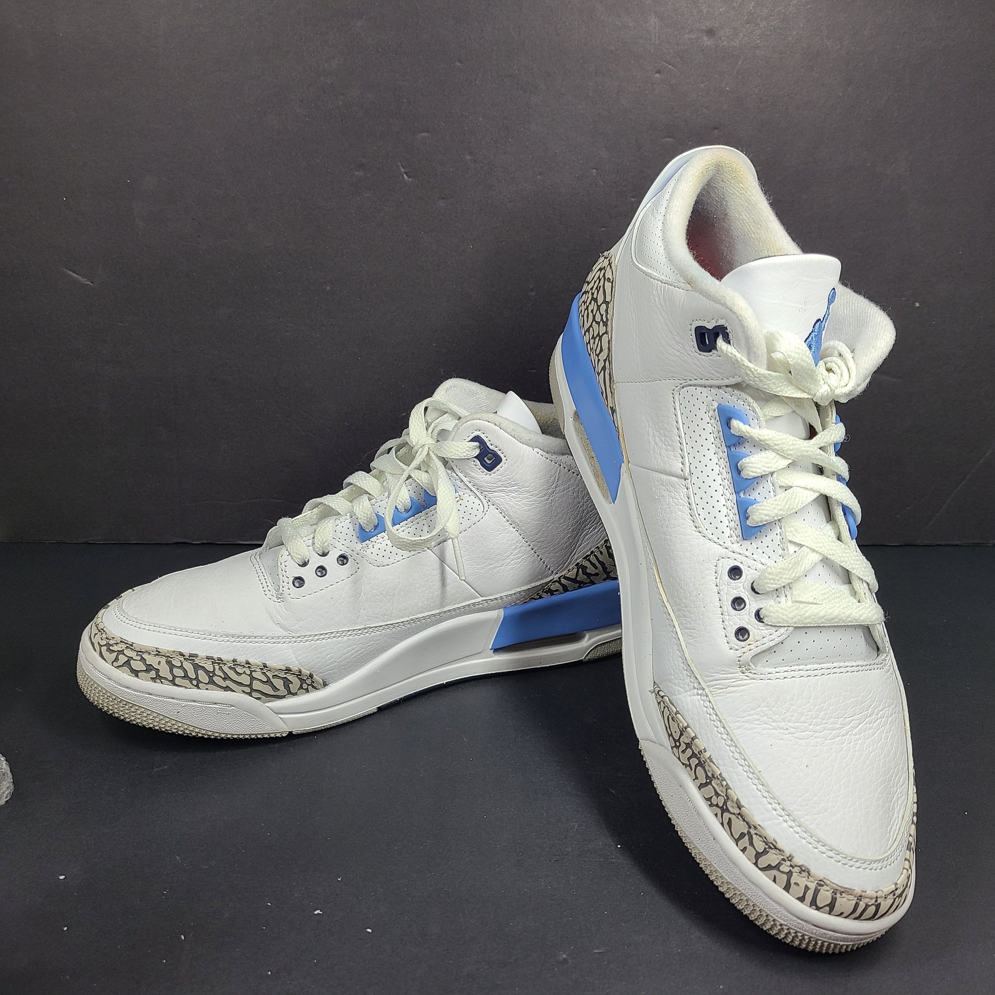 Air Jordan 3 Retro UNC in white and valor blue with elephant-print accents and blue detailing.