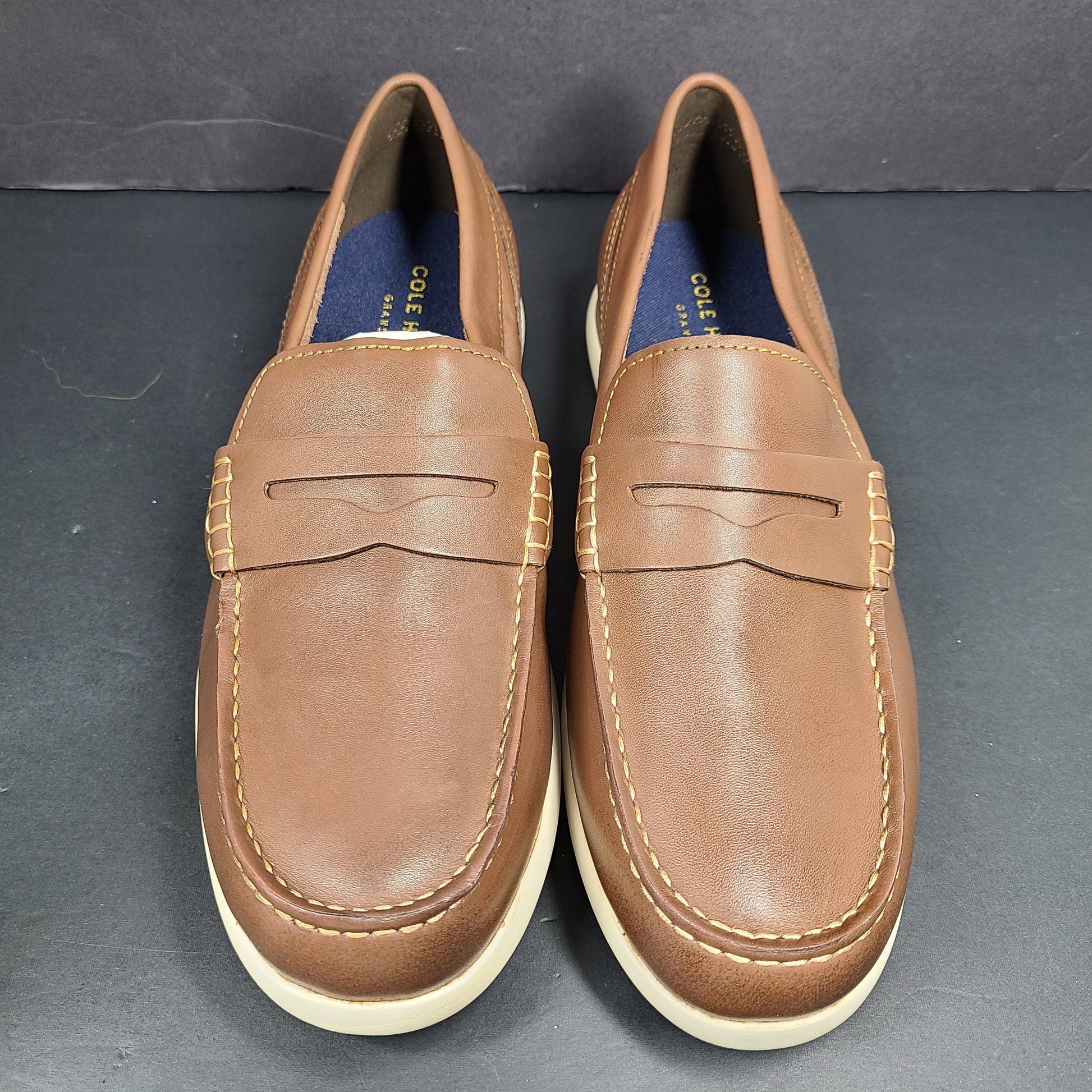 Cole Haan Grand 360 brown penny loafers size 11M, model C33028, with manmade lining.
