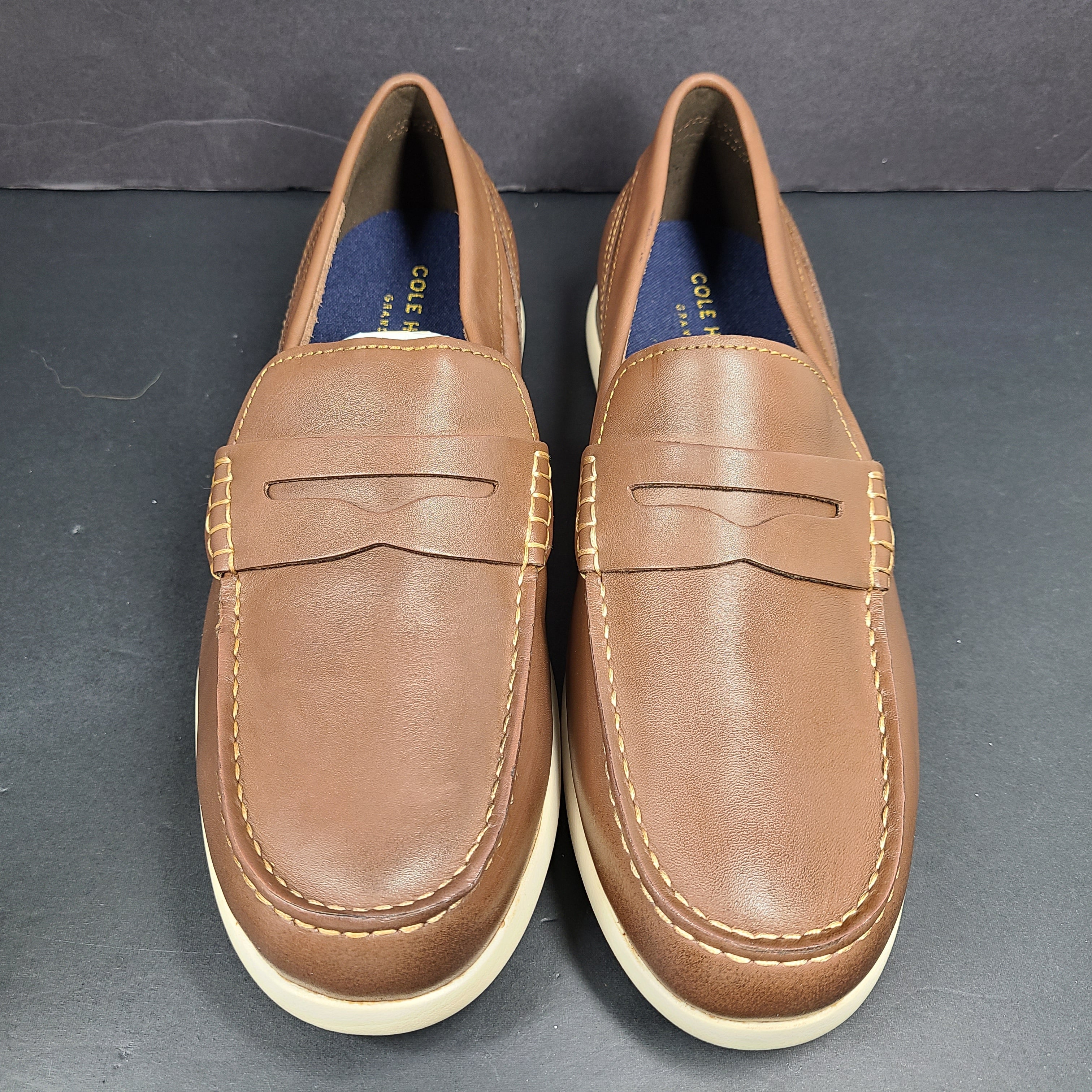 Cole Haan Grand 360 brown penny loafers size 11M, model C33028, with manmade lining.
