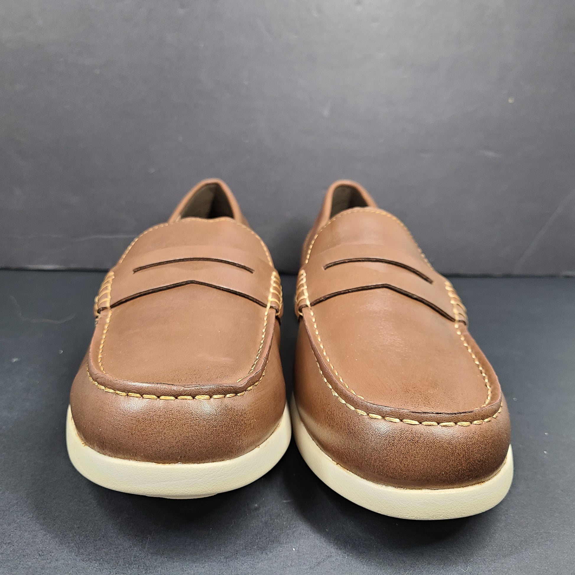 Cole Haan Grand 360 brown penny loafers size 11M, model C33028, with manmade lining.