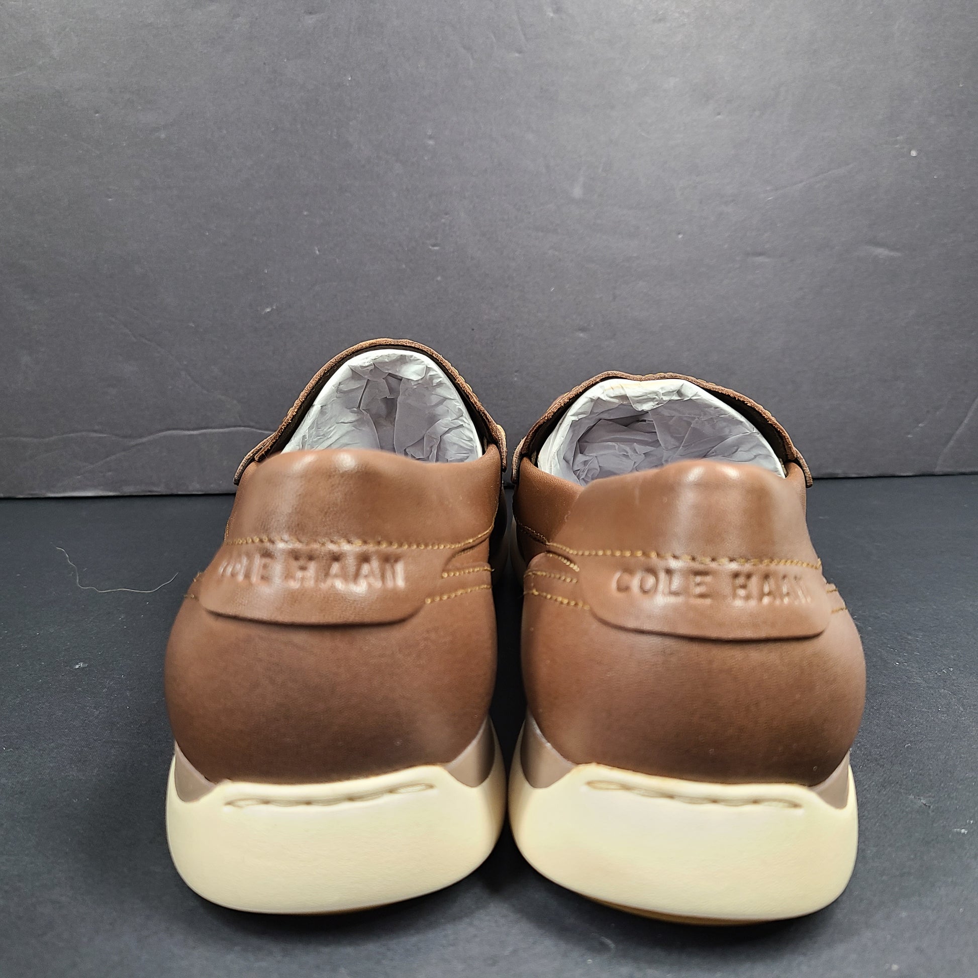Cole Haan Grand 360 brown penny loafers size 11M, model C33028, with manmade lining.