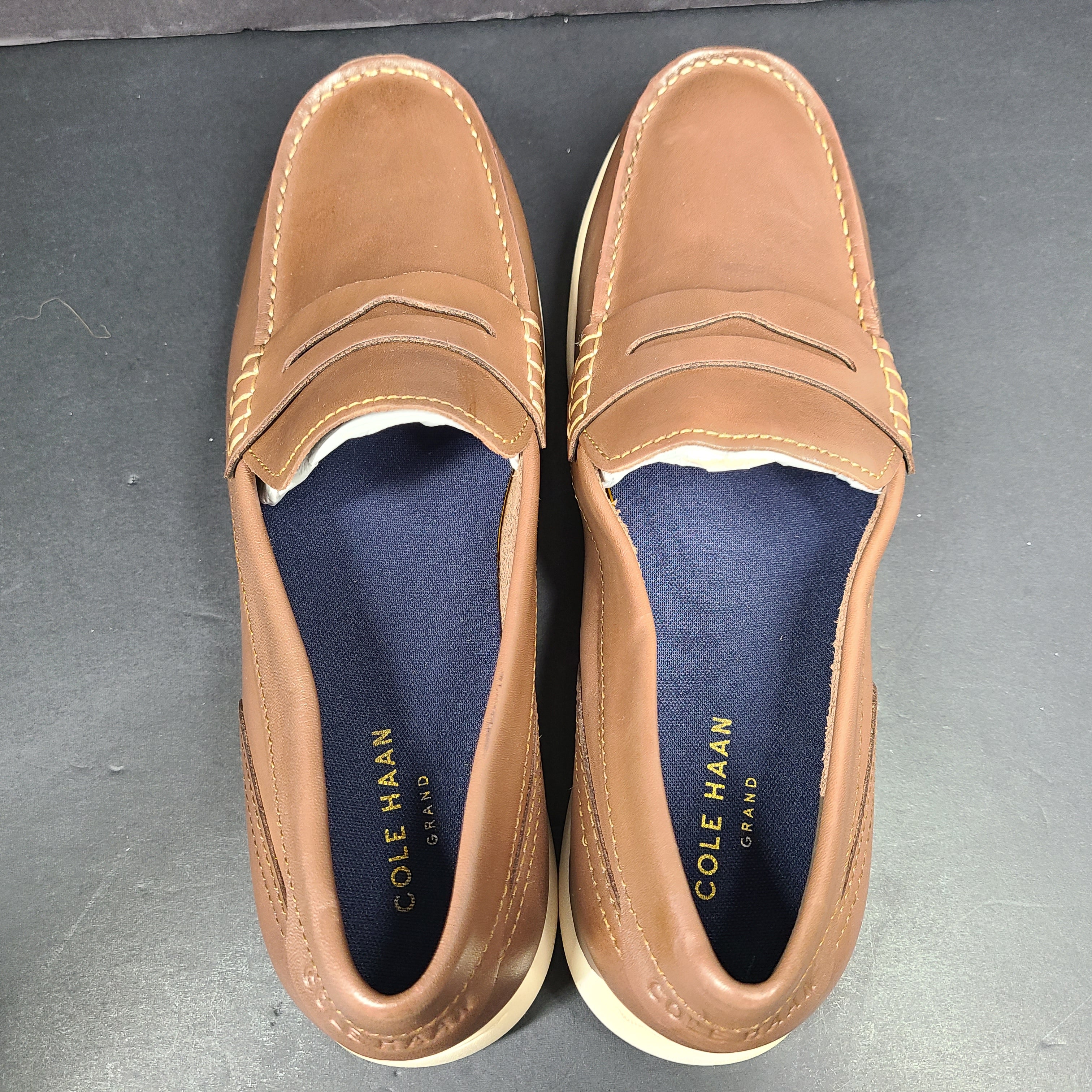 Cole Haan Grand 360 brown penny loafers size 11M, model C33028, with manmade lining.
