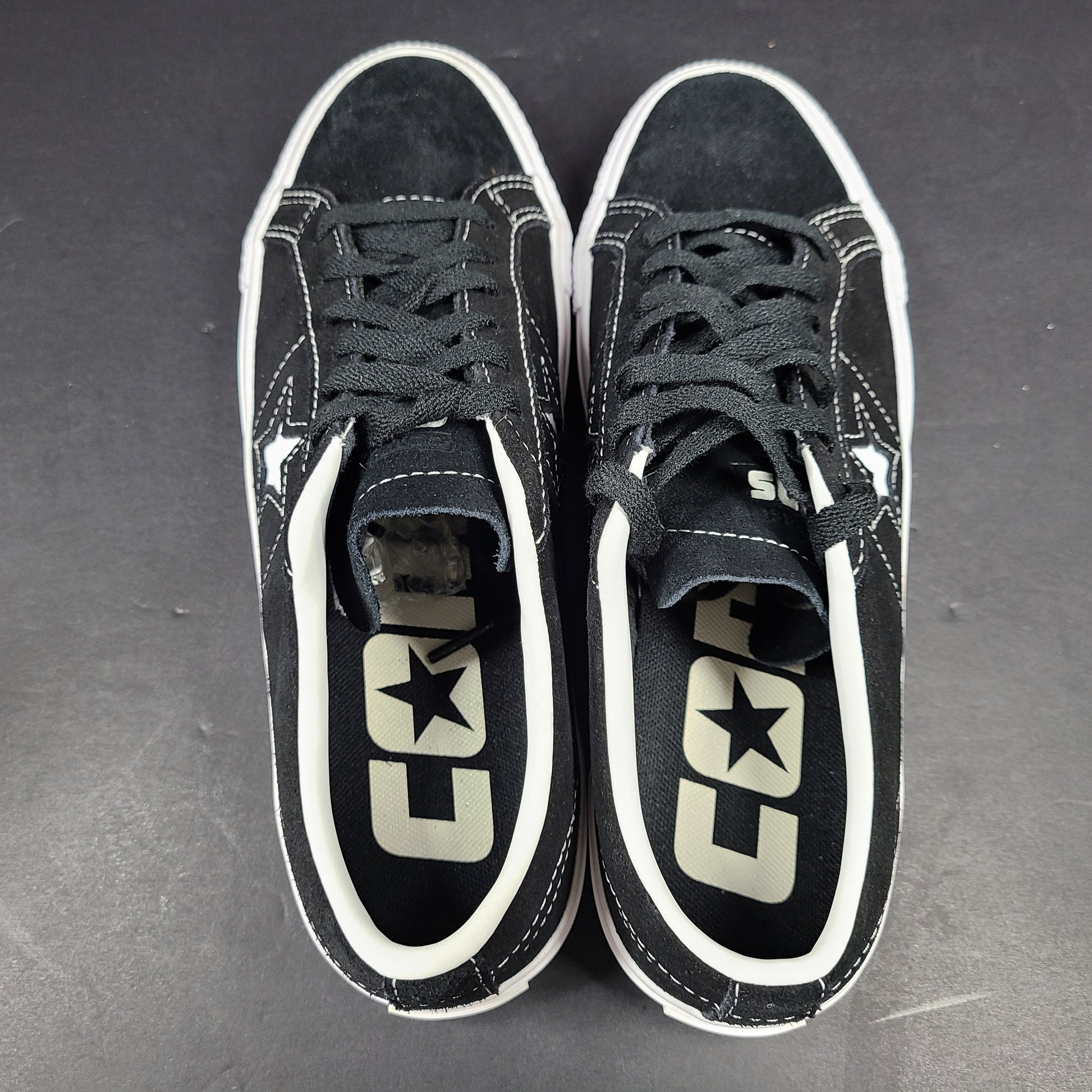 Black and white Converse One Star Pro OX low-top skate shoes in leather with textile lining and a rubber outsole.