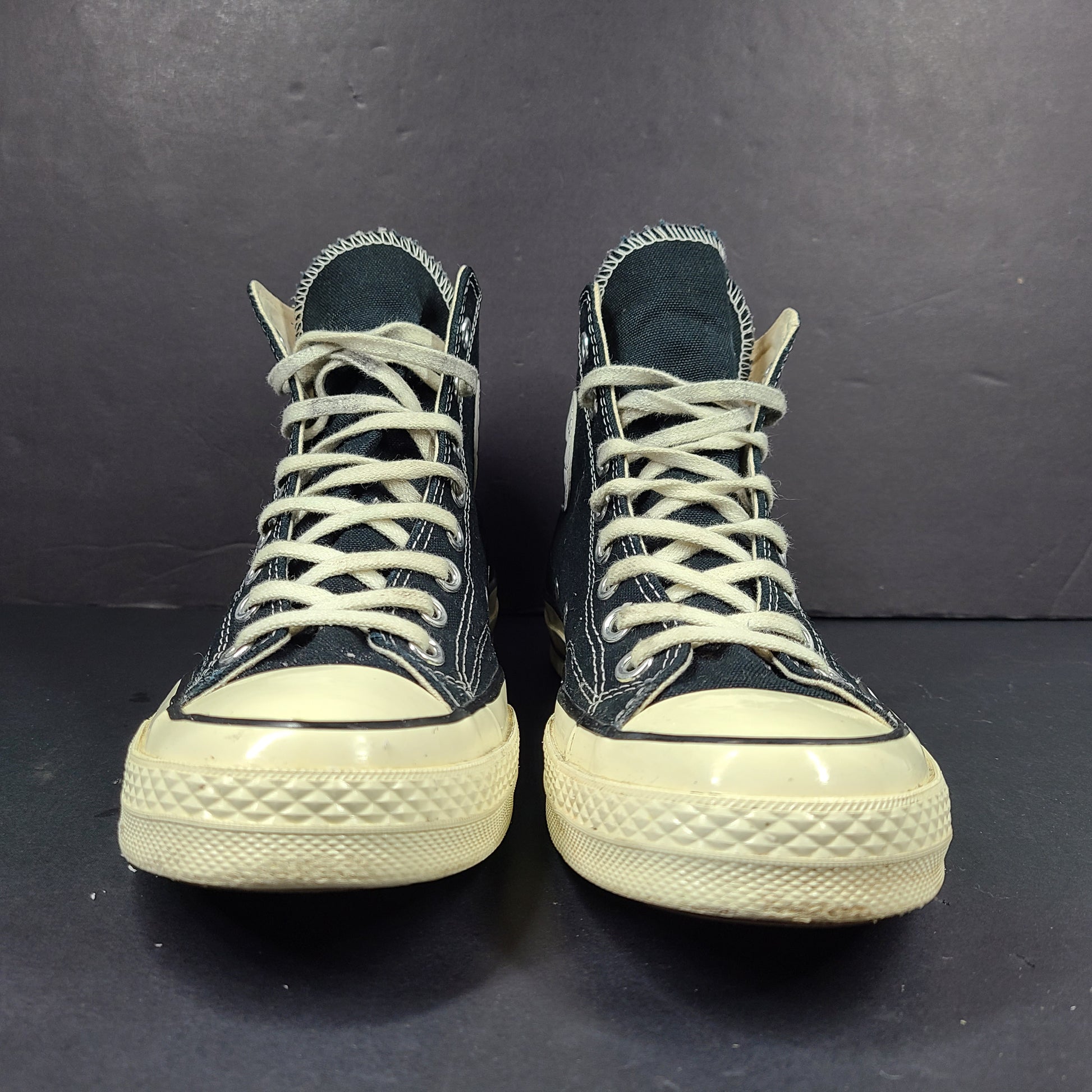 Classic black Converse Chuck Taylor All Star high-top sneakers with white rubber sole and ankle patch.