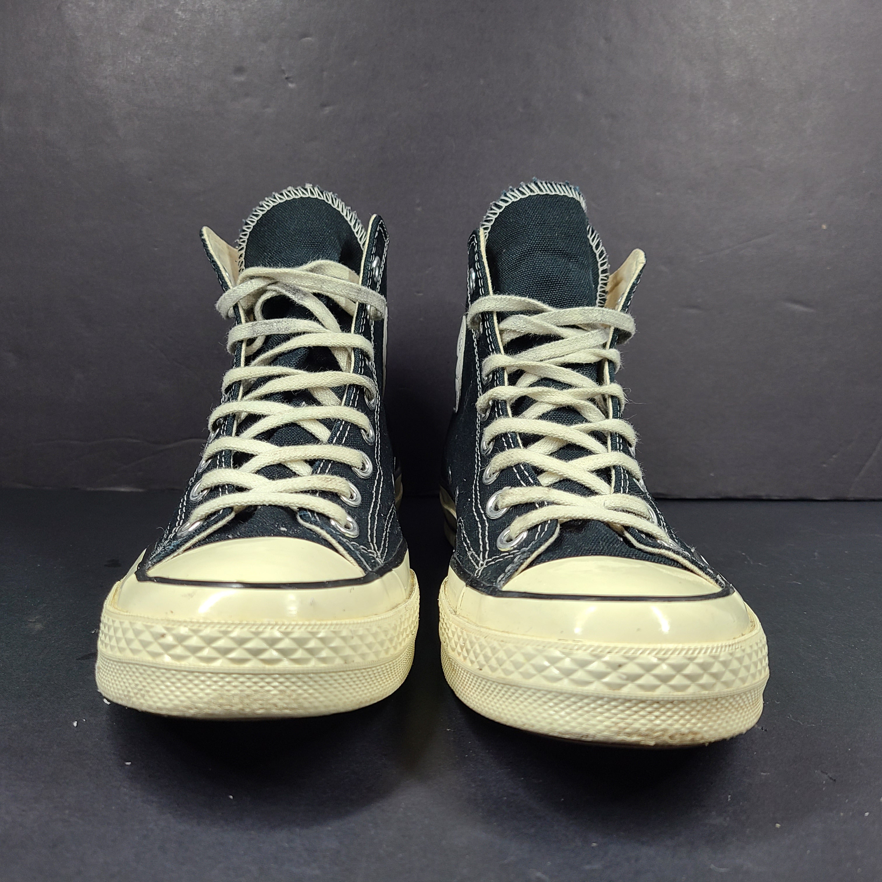 Classic black Converse Chuck Taylor All Star high-top sneakers with white rubber sole and ankle patch.