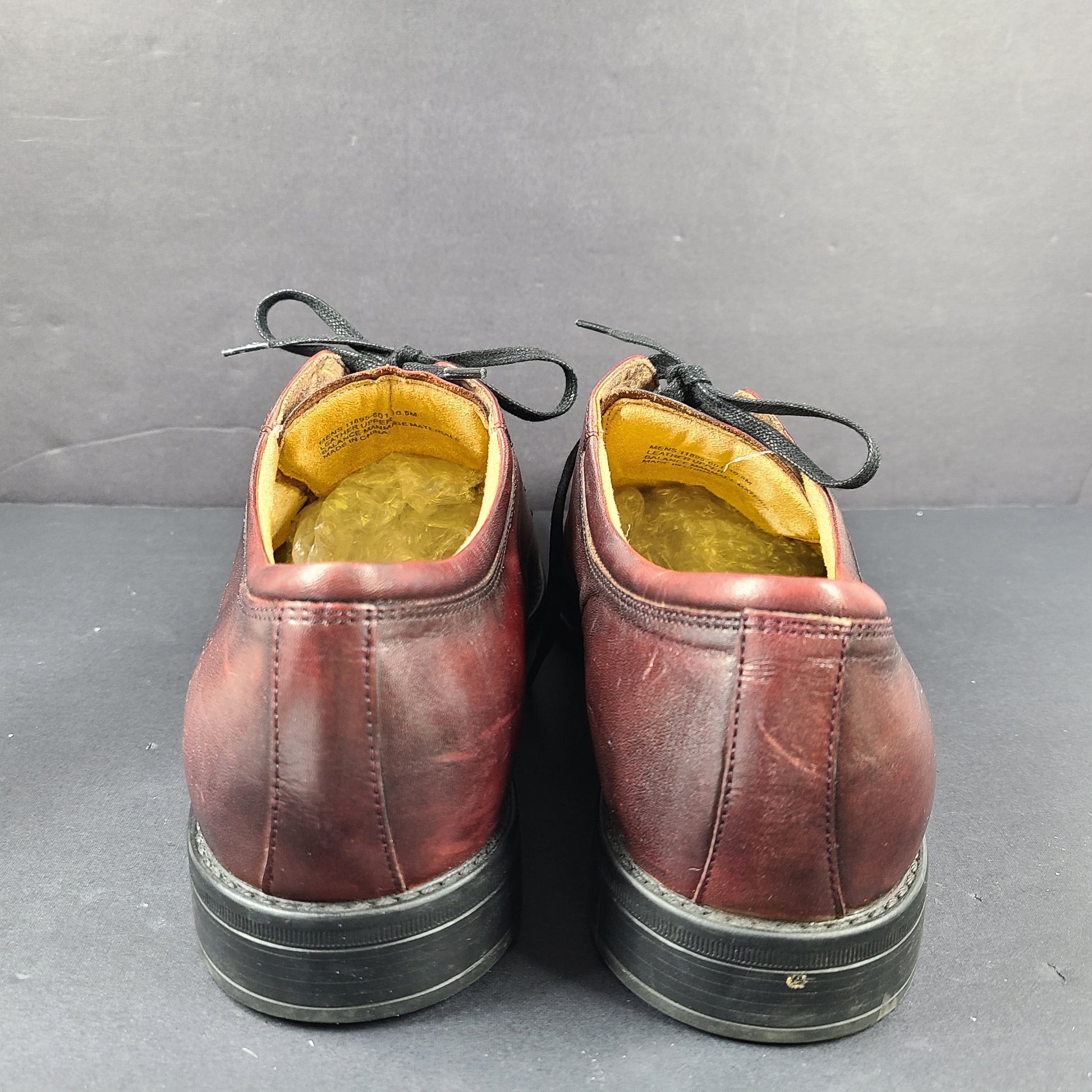 Brown Florsheim men's leather dress shoe in U.S. size 10.5 M with manmade sole balance.