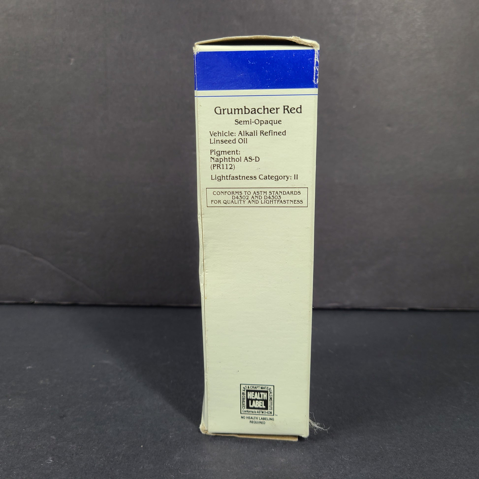 Three artist-grade oil paint colors in cobalt blue, burnt sienna, and red for studio painting.