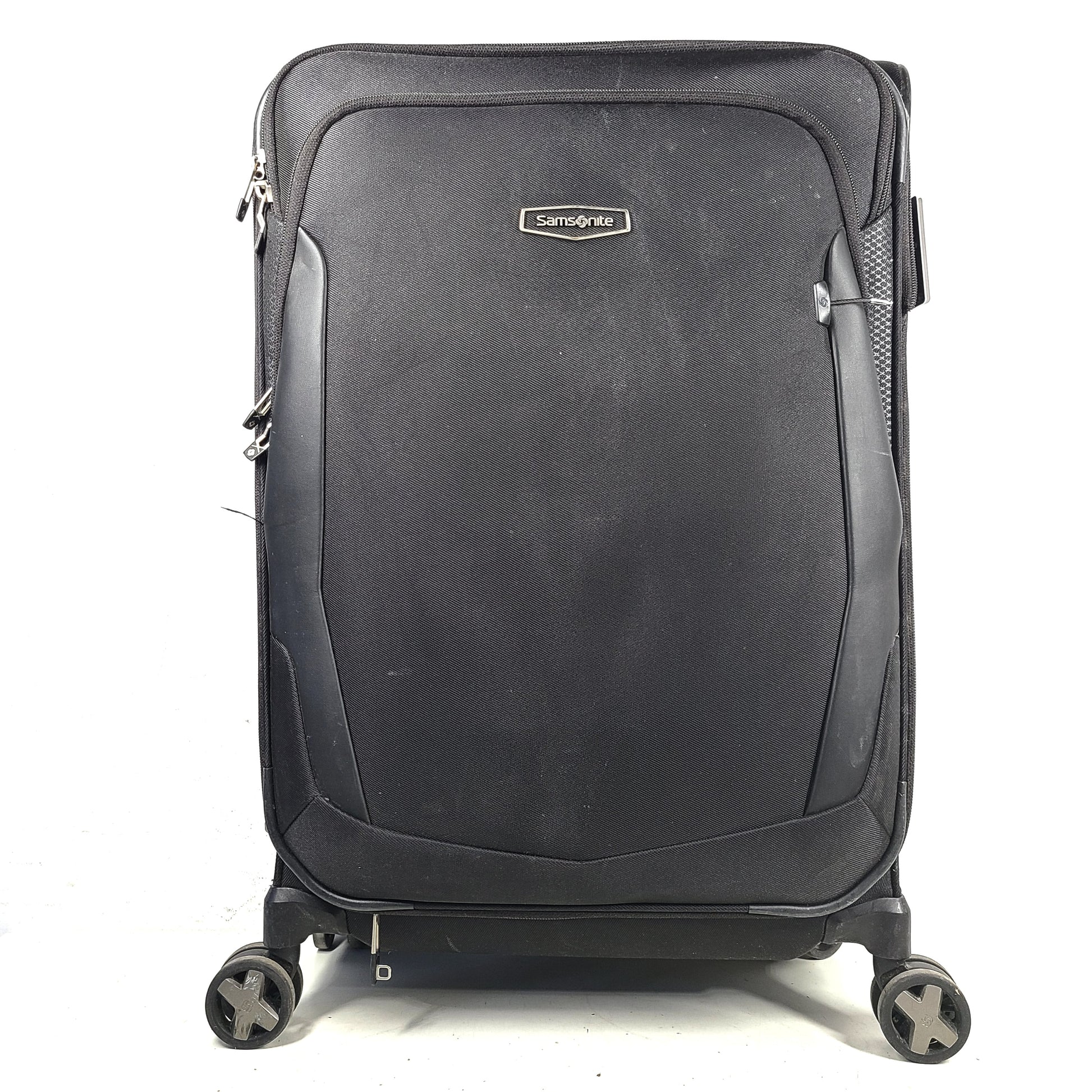 Black Samsonite Spinner 71/26 EXP suitcase with four spinner wheels and a telescoping handle.