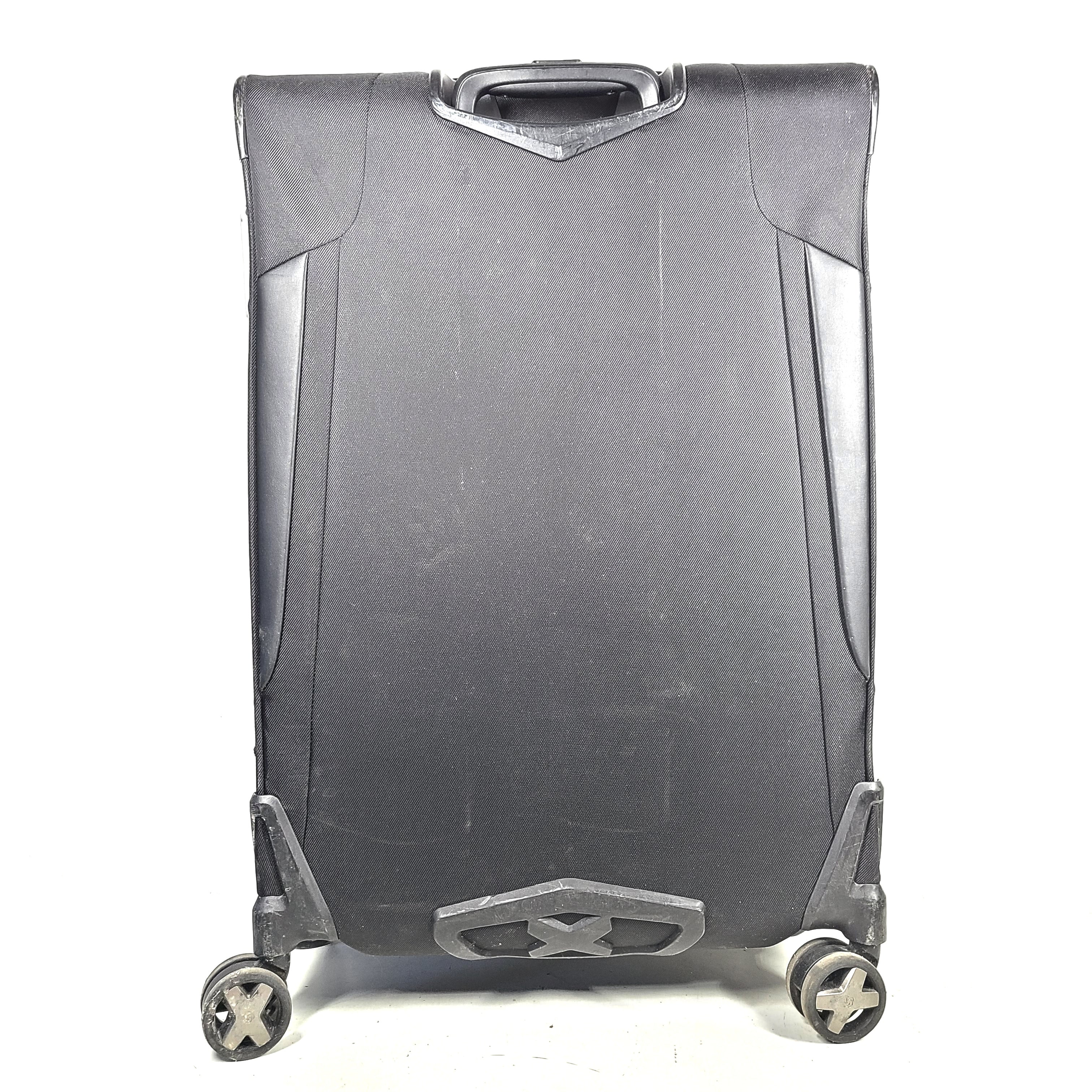 Black Samsonite Spinner 71/26 EXP suitcase with four spinner wheels and a telescoping handle.
