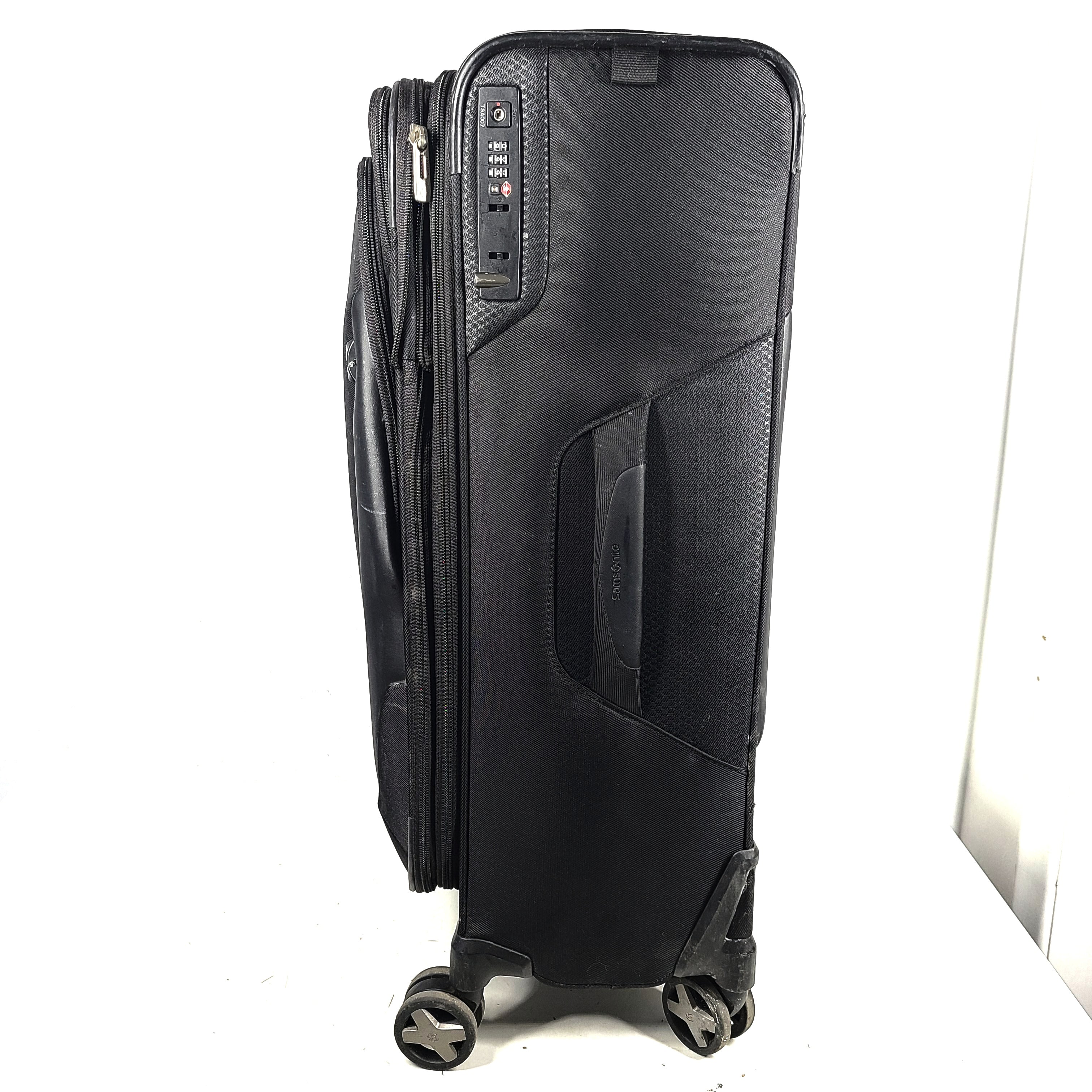 Black Samsonite Spinner 71/26 EXP suitcase with four spinner wheels and a telescoping handle.