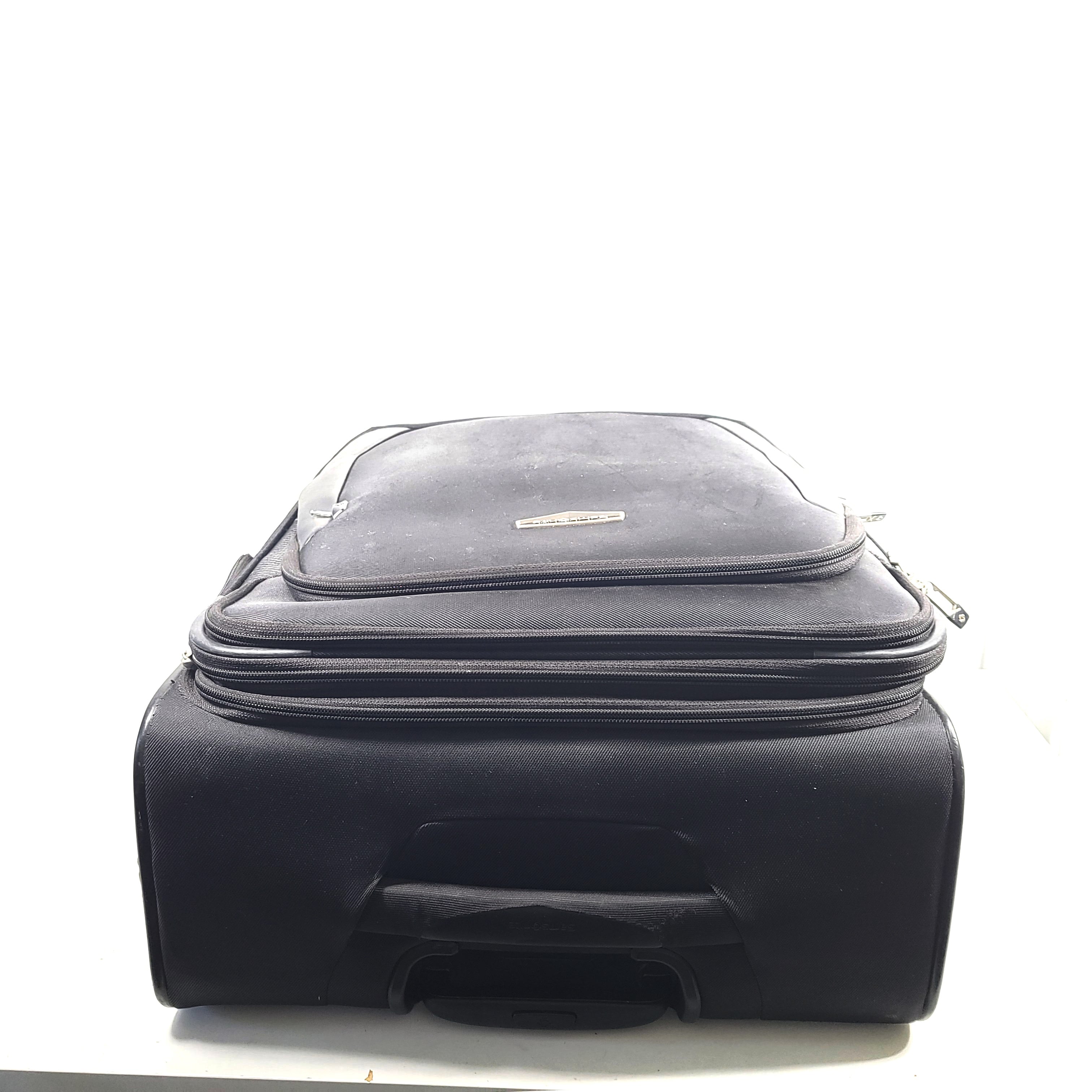 Black Samsonite Spinner 71/26 EXP suitcase with four spinner wheels and a telescoping handle.