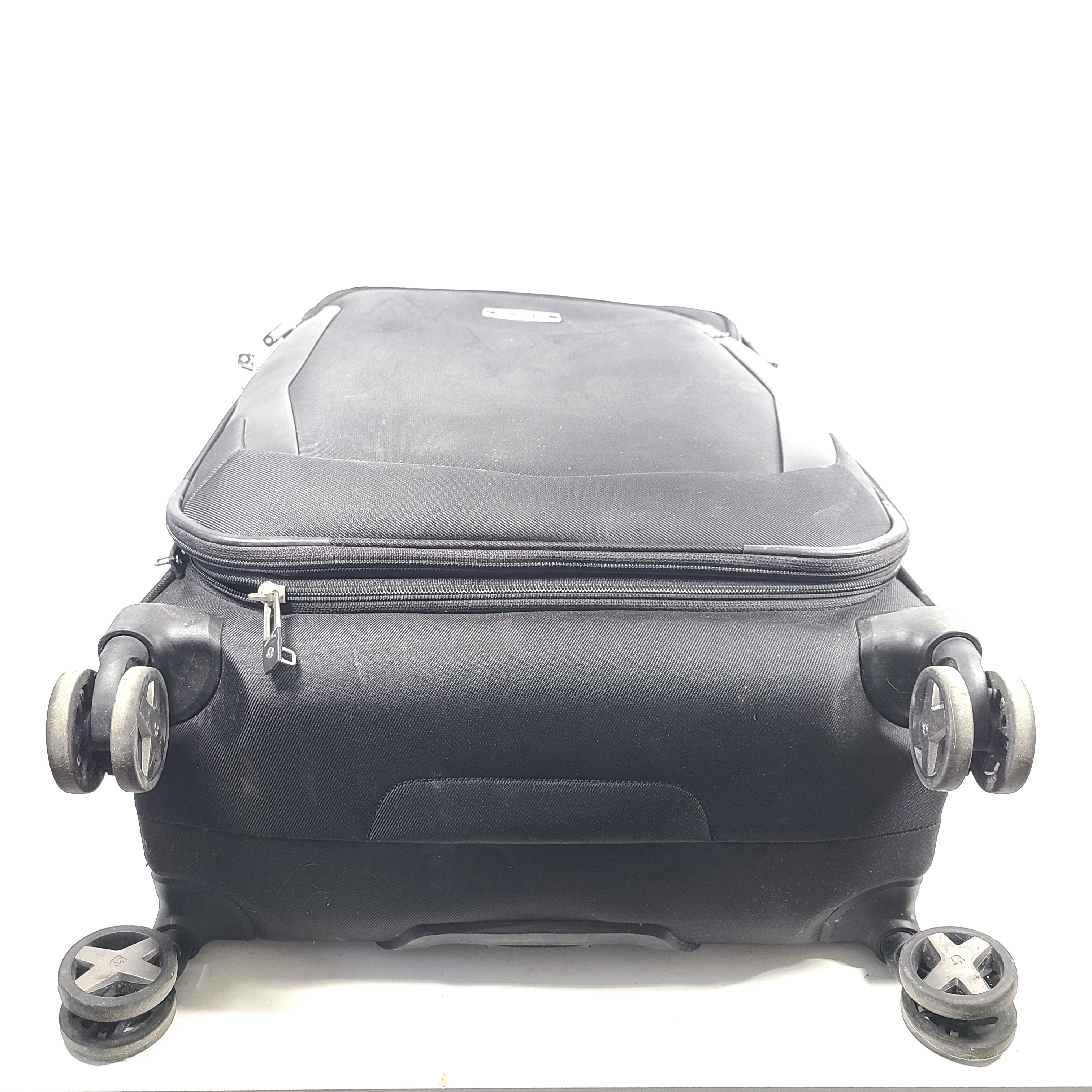 Black Samsonite Spinner 71/26 EXP suitcase with four spinner wheels and a telescoping handle.