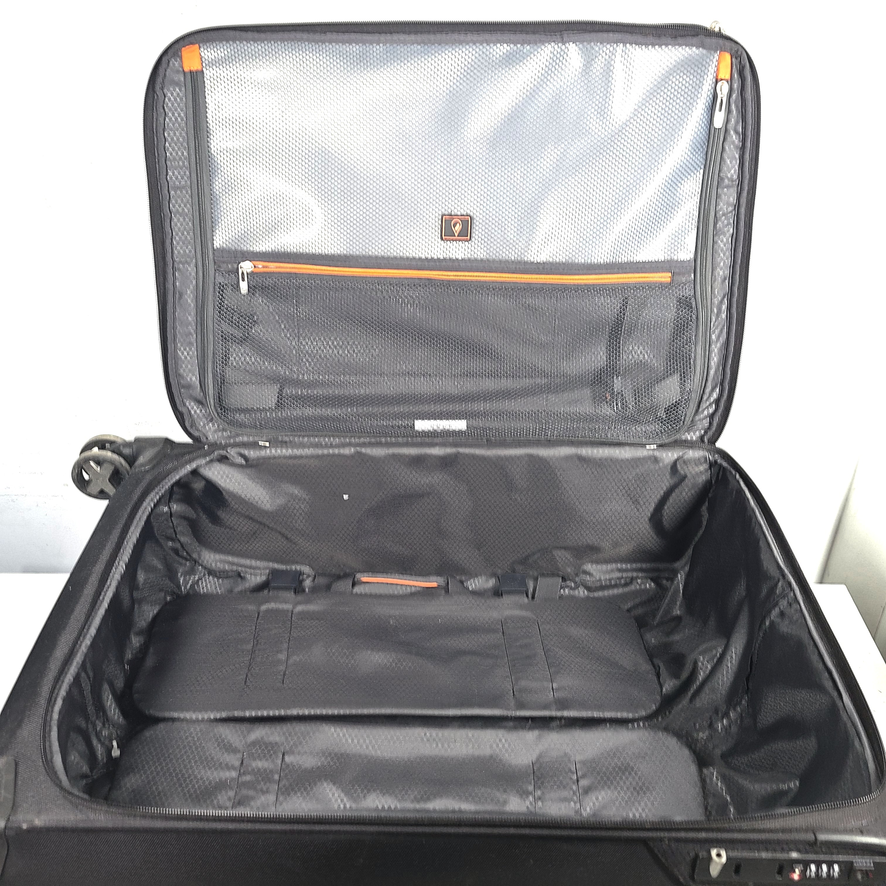 Black Samsonite Spinner 71/26 EXP suitcase with four spinner wheels and a telescoping handle.