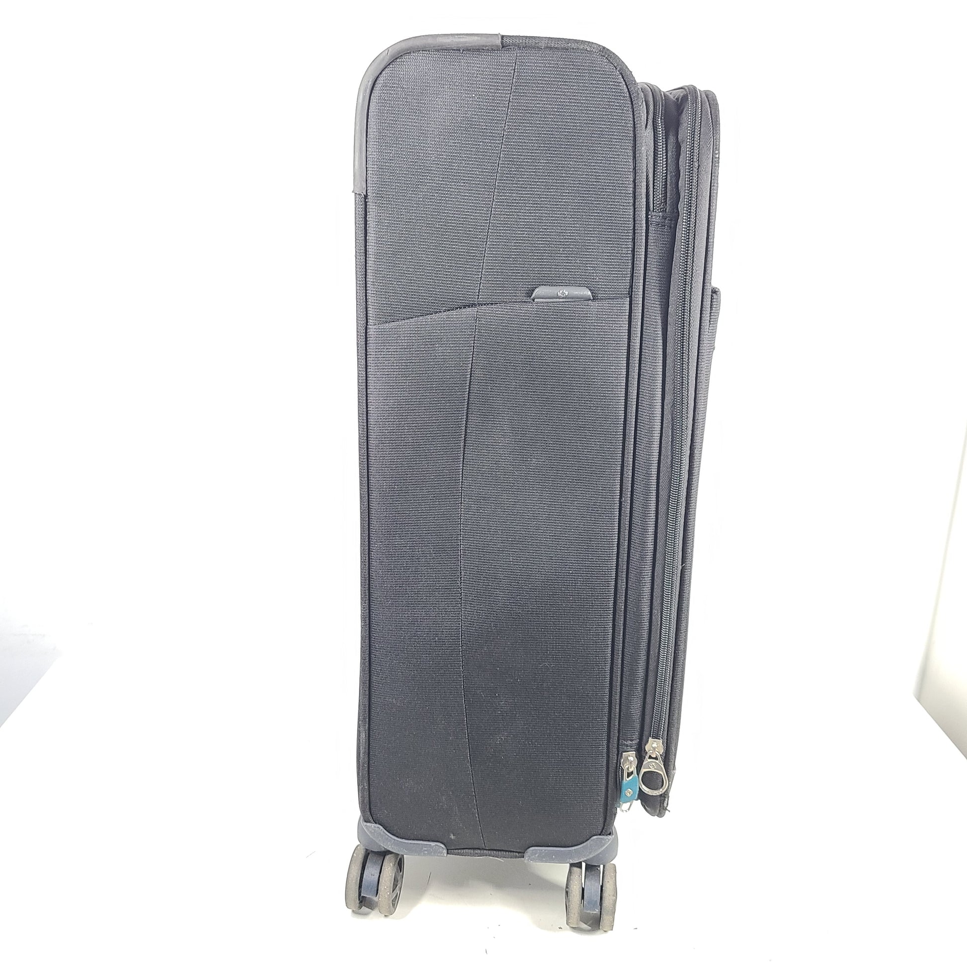 Black Samsonite 67/24 EXP spinner suitcase with scuffs and marks on the exterior.