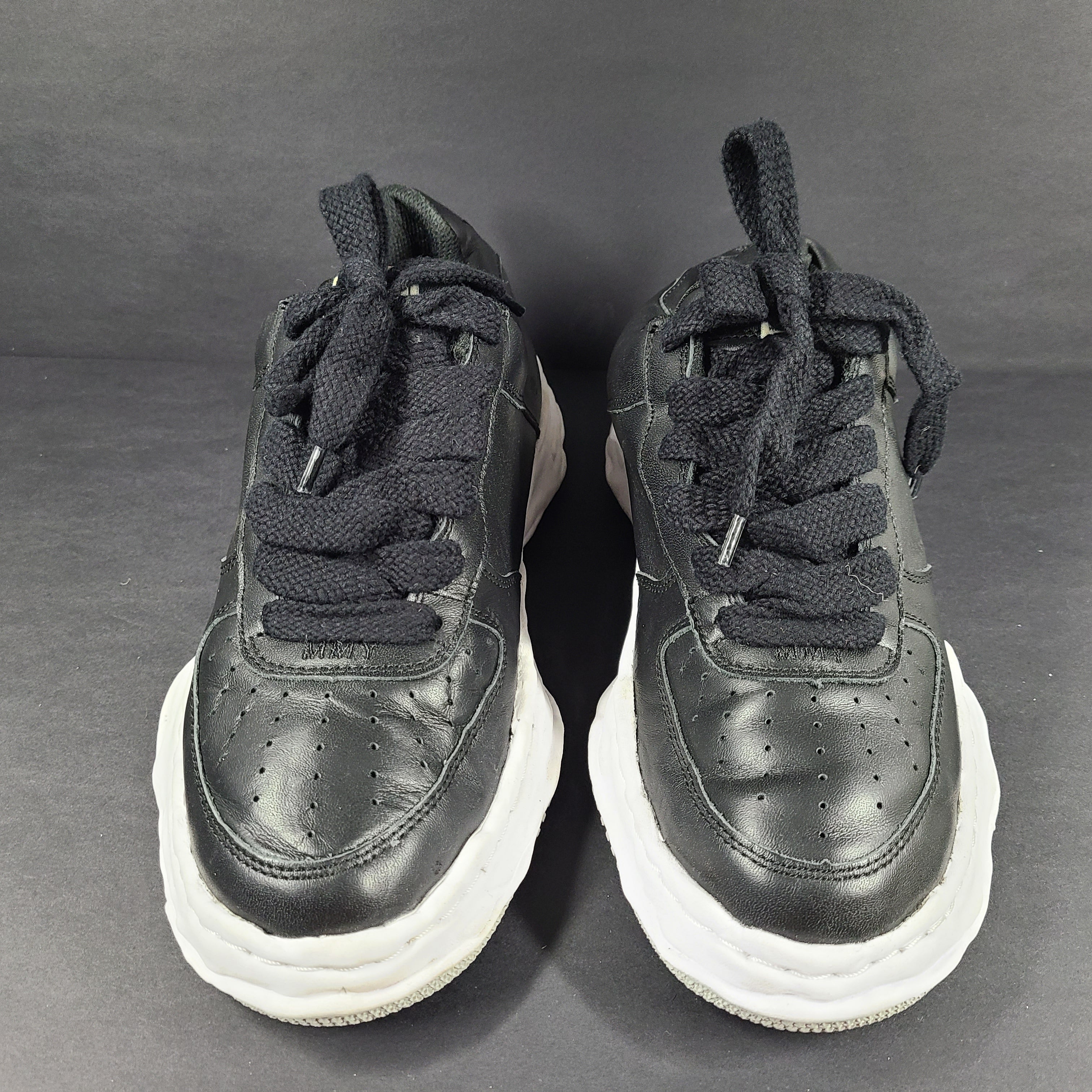 Black and white Maison Mihara Yasuhiro Wayne low-top leather sneakers with original sculpted OG sole and MMY branding.